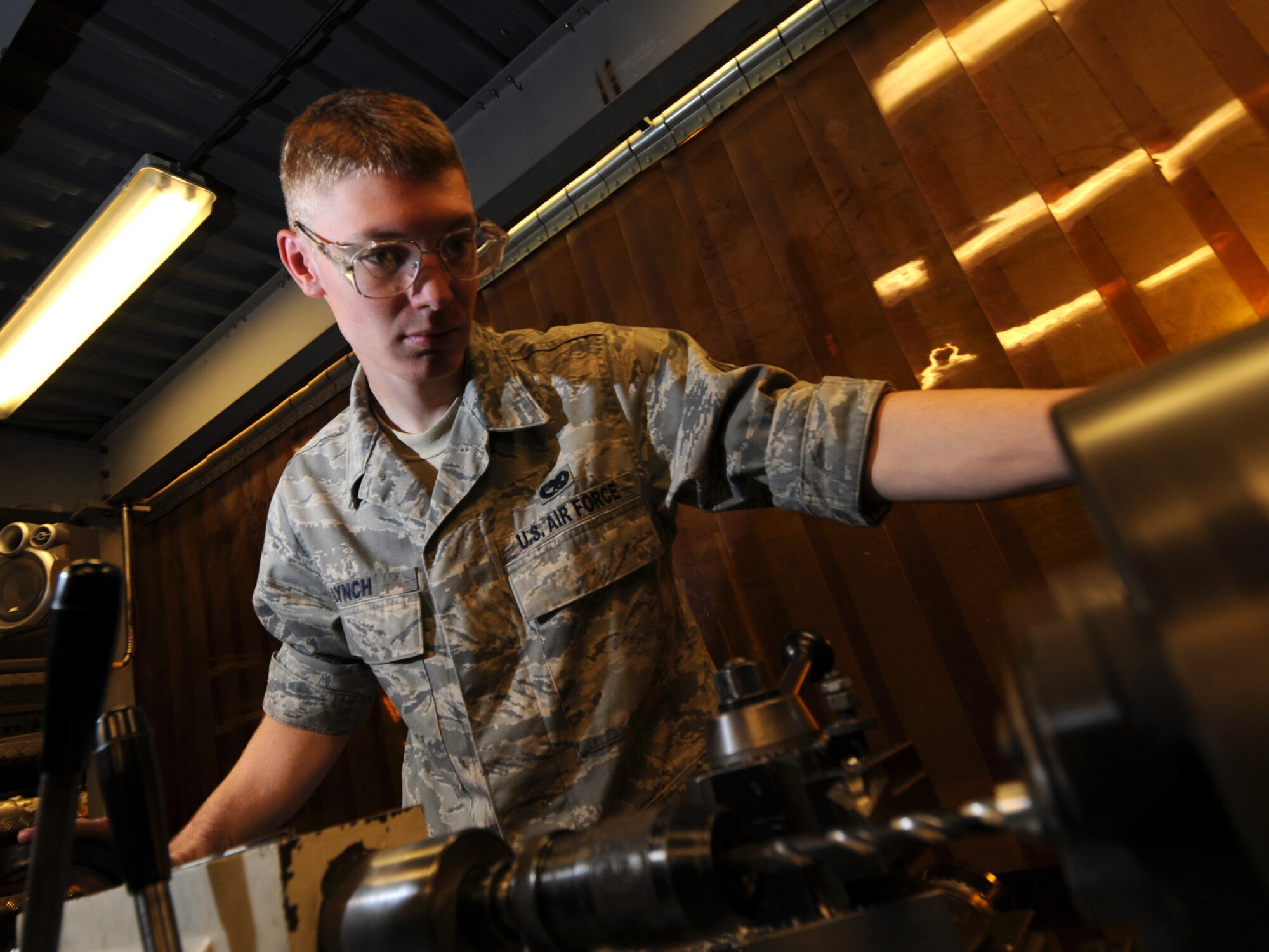 Senior Airman Steven Lynch, 379th Expeditionary Maintenance Squadron aircraft metals technology journeyman, bores a hole in a part using a Colchester lathe, Oct. 5. The 379 EMXS fabrications flight performs maintenance on external sheet metal, internal framework, composites, fiberglass and plastic, as well as tubing and cable assemblies, on aircraft. Airman Lynch is deployed from Grand Forks Air Force Base, N.D. in support of Operations Iraqi and Enduring Freedom. (U.S. Air Force Photo/Tech. Sgt. Jason W. Edwards)