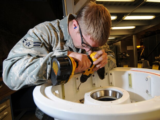 Airman 1st Class Timothy Thomas, 379th Expeditionary Maintenance Squadron aircraft structural maintenance journeyman, removes screws from an aircraft wheel in preparation for evaluation and repair, Oct. 5. The 379 EMXS fabrications flight performs maintenance on external sheet metal, internal framework, composites, fiberglass and plastic, as well as tubing and cable assemblies, on aircraft. Airman Thomas is deployed from McConnell Air Force Base, Kan. in support of Operations Iraqi and Enduring Freedom. (U.S. Air Force Photo/Tech. Sgt. Jason W. Edwards)
