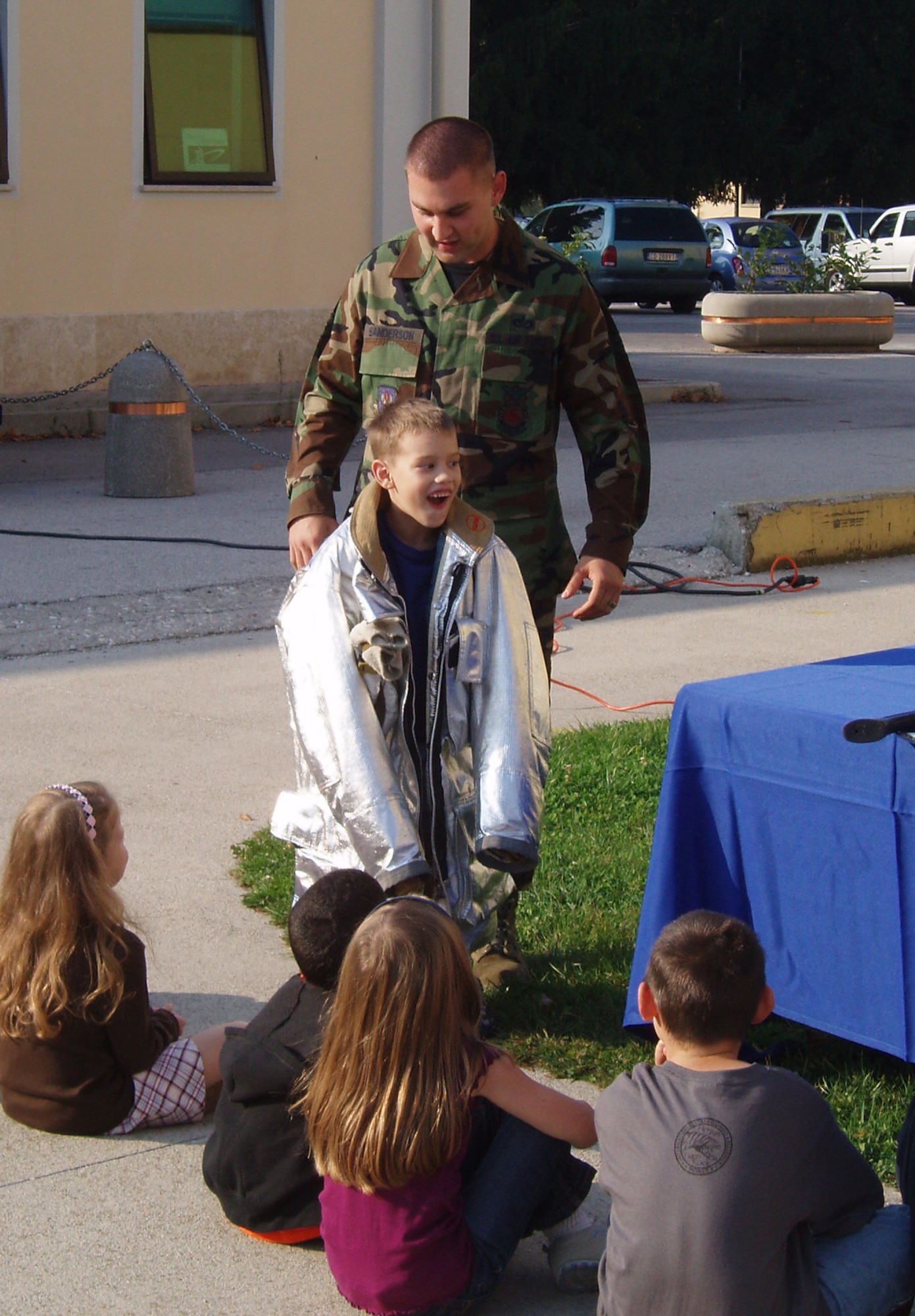 Staff Sgt. Brandon Sanderson, 31st Civil Engineer Squadron firefighter, shows Aviano Elementary School students some of the equipment firefighters use Sept. 29, 2009 at Aviano Air Base, Italy. Base firefighters visted with students as part of National Fire Prevention Week. (U.S. Air Force photo/Senior Master Sgt. Coben Scott)  