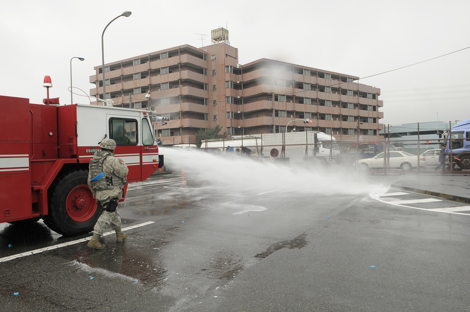 YOKOTA AIR BASE, Japan -- Members of the 374th Civil Engineer Squadron Fire Department help defenders from the 374th Security Forces Squadron to disperse simulated protestors outside the base's supply gate Oct. 6 during Beverly Bearcat 09-05, an operational readiness inspection conducted by the Pacific Air Forces' Inspector General. (U.S. Air Force photo/Airman 1st Class Sean Martin)