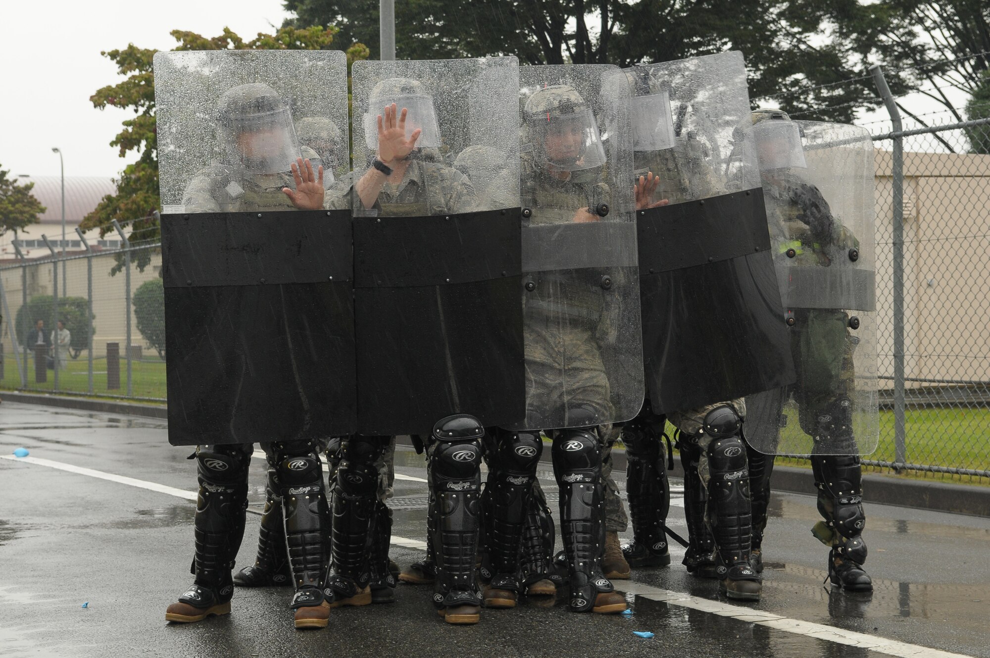 YOKOTA AIR BASE, Japan -- Members of the 374th Security Forces Squadron respond to simulated protestors outside the base's supply gate Oct. 6 during Beverly Bearcat 09-05, an operational readiness inspection conducted by the Pacific Air Forces' Inspector General. (U.S. Air Force photo/Airman 1st Class Sean Martin)