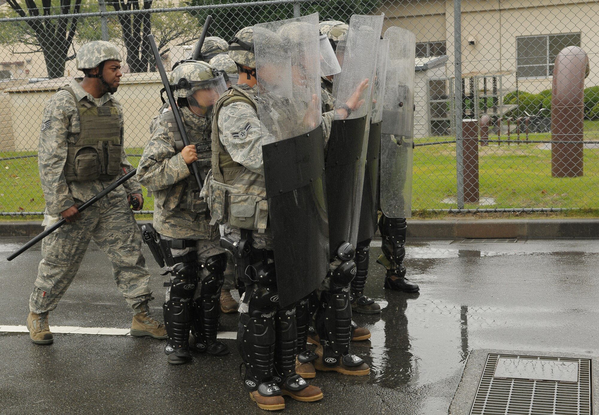 YOKOTA AIR BASE, Japan -- Members of the 374th Security Forces Squadron respond to simulated protestors outside the base's supply gate Oct. 6 during Beverly Bearcat 09-05, an operational readiness inspection conducted by the Pacific Air Forces' Inspector General. (U.S. Air Force photo/Airman 1st Class Sean Martin)