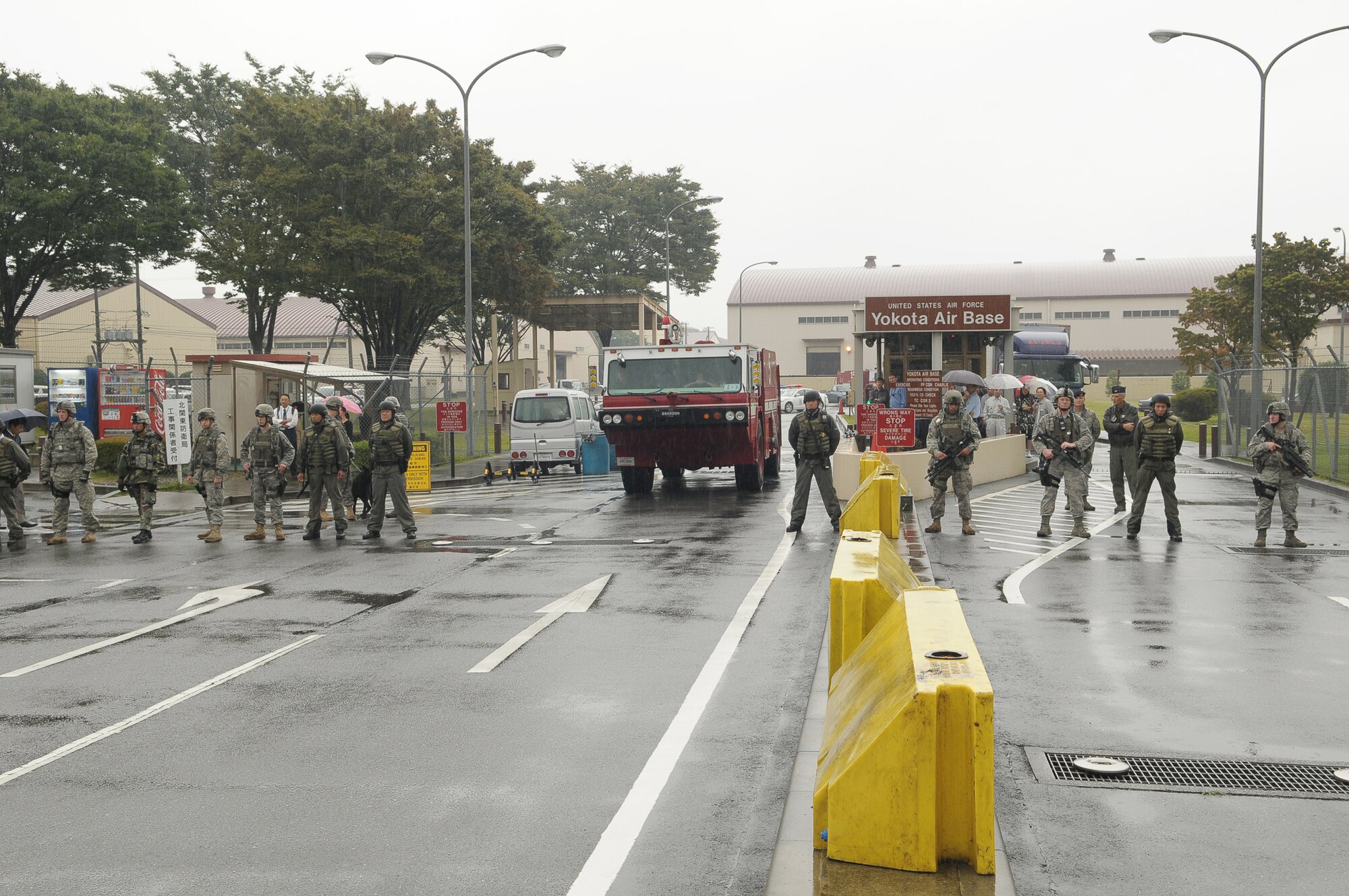 YOKOTA AIR BASE, Japan -- Members of the 374th Security Forces Squadron respond to simulated protestors outside the base's supply gate Oct. 6 during Beverly Bearcat 09-05, an operational readiness inspection conducted by the Pacific Air Forces' Inspector General. (U.S. Air Force photo/Airman 1st Class Sean Martin)