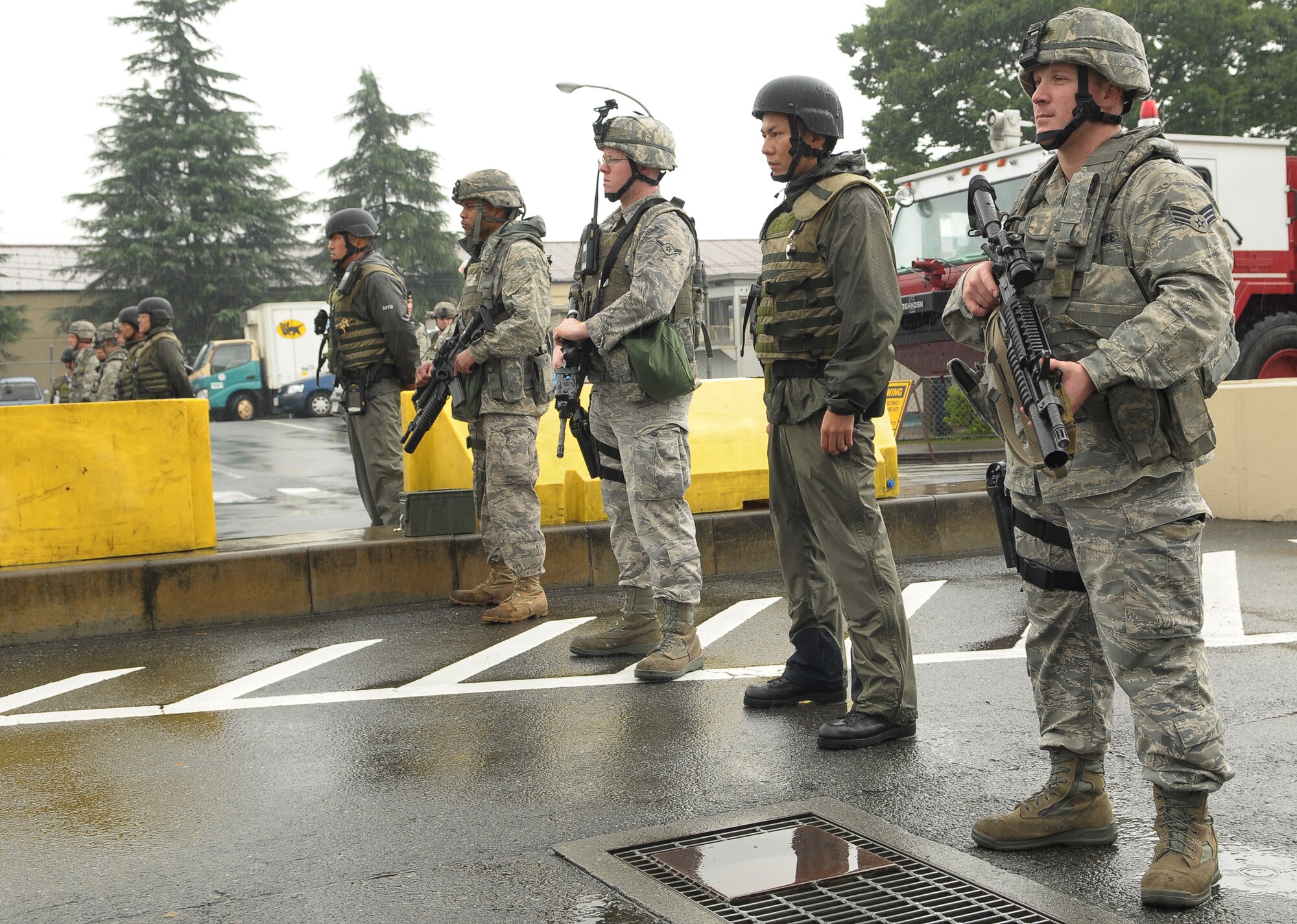 YOKOTA AIR BASE, Japan -- Members of the 374th Security Forces Squadron respond to simulated protestors outside the base's supply gate Oct. 6 during Beverly Bearcat 09-05, an operational readiness inspection conducted by the Pacific Air Forces' Inspector General. (U.S. Air Force photo/Airman 1st Class Sean Martin)