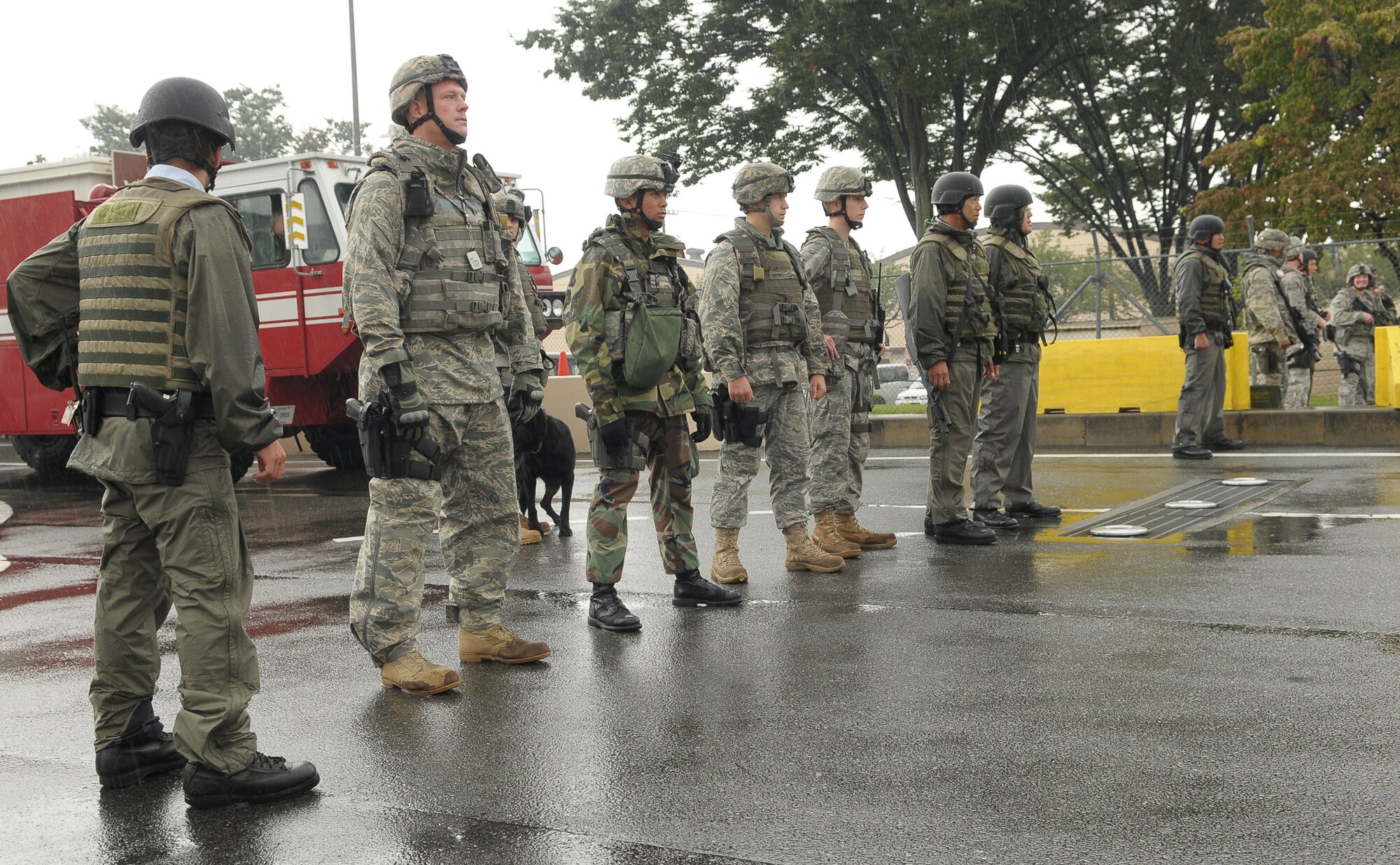 YOKOTA AIR BASE, Japan -- Members of the 374th Security Forces Squadron respond to simulated protestors outside the base's supply gate Oct. 6 during Beverly Bearcat 09-05, an operational readiness inspection conducted by the Pacific Air Forces' Inspector General. (U.S. Air Force photo/Airman 1st Class Sean Martin)