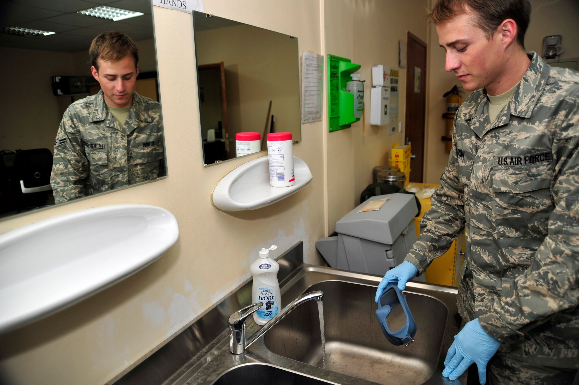 SOUTHWEST ASIA -Airman 1st Class James Dunn, 380th Expeditionary Operations Support Squadron, washes aircrew oxygen mask goggles prior to use here Oct. 5, 2009. Airman Dunn is deployed from Tinker Air Force Base, Okla., and grew up in Wichita Falls, Texas. (U.S. Air Force photo/Tech. Sgt. Charles Larkin Sr)