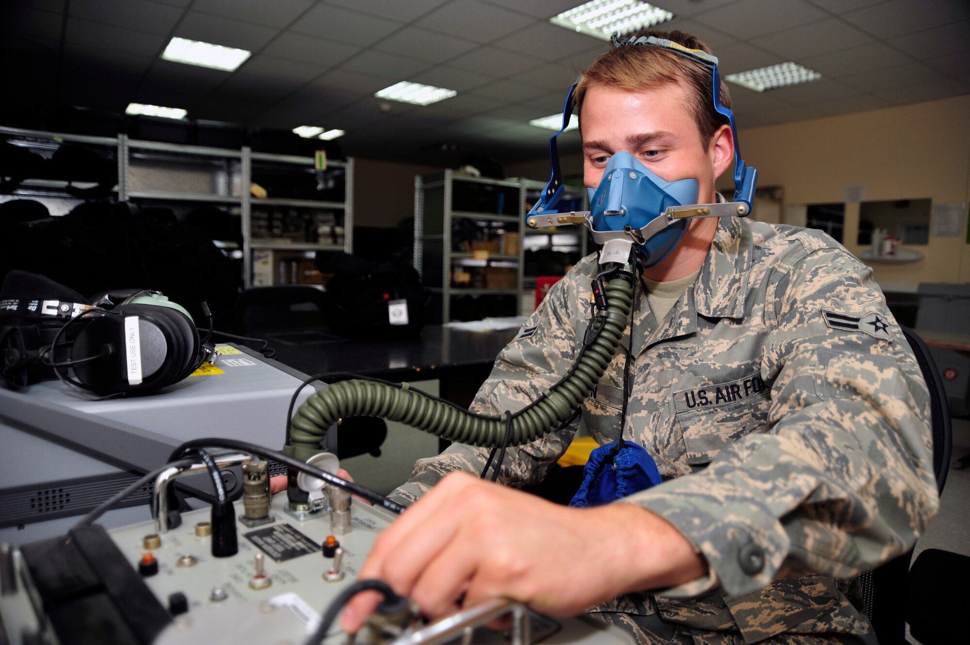 SOUTHWEST ASIA -Airman 1st Class James Dunn, 380th Expeditionary Operations Support Squadron, tests an aircrew oxygen mask for leaks here Oct. 5, 2009. Airman Dunn is deployed from Tinker Air Force Base, Okla., and grew up in Wichita Falls, Texas. (U.S. Air Force photo/Tech. Sgt. Charles Larkin Sr)