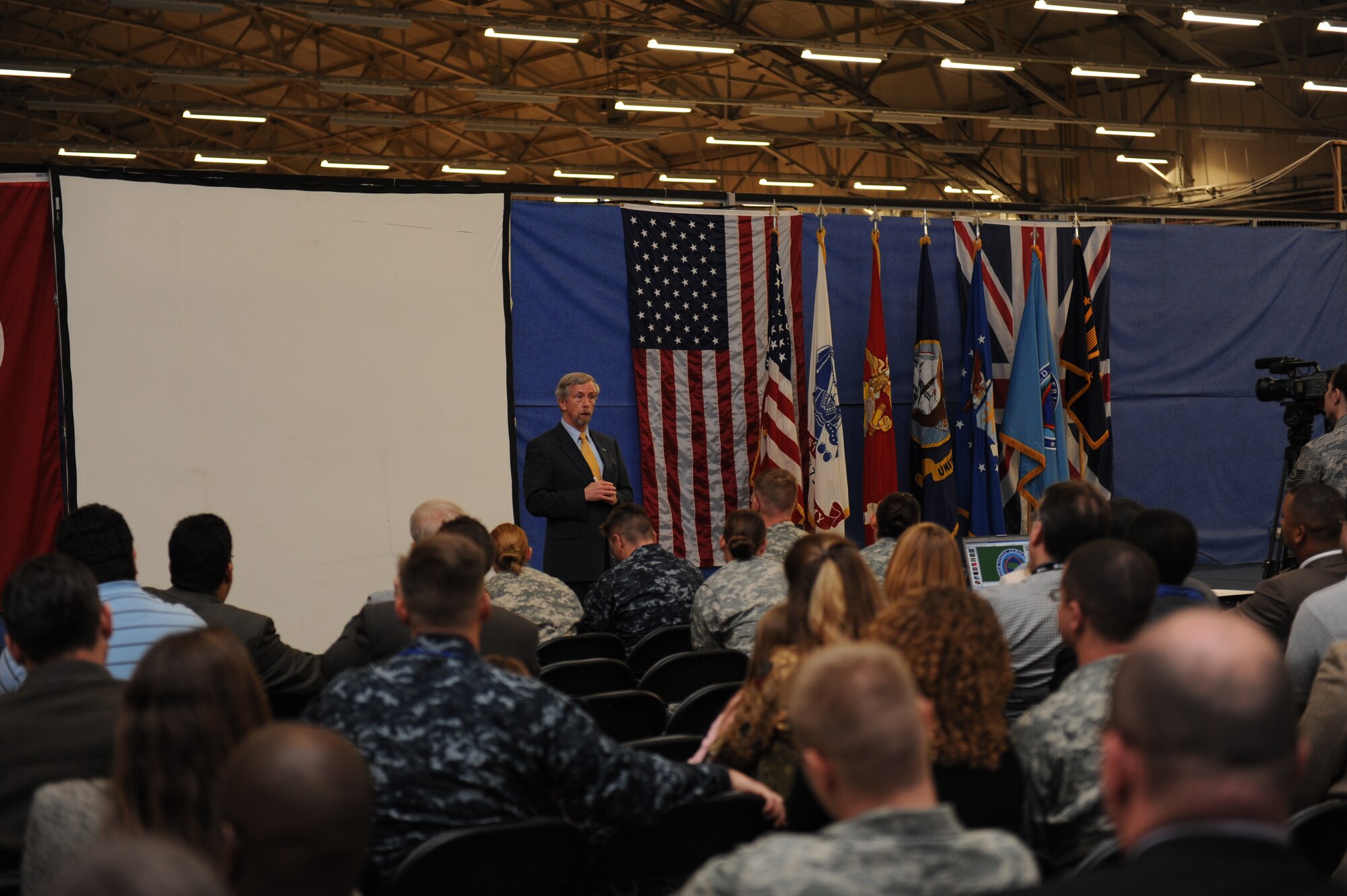 IKD-M Senior Enlisted Advisor, U.S. Air Force Senior Master Sgt. Thomas F. Good introduces Mr. Terry Ford, Director, IKD Stuttgart to a packed house of IKD-M team members and their families.  (Photo by Air Force Staff Sgt. Javier Cruz)