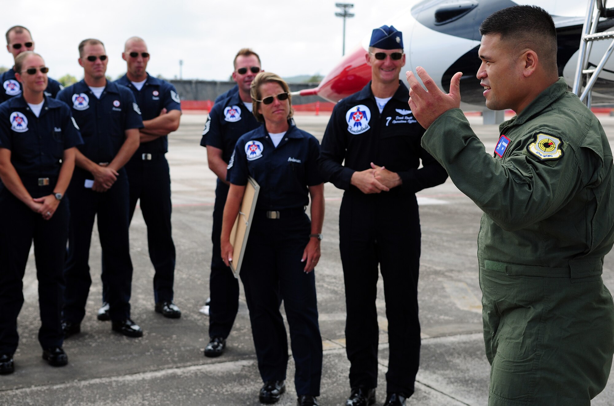 ANDERSEN AIR FORCE BASE, Guam - Army Sgt. Dan Elliott thanks crew members of the U.S. Air Force Aerial Demonstration Squadron here Oct. 6 for allowing him to fly over Andersen AFB and the island of Guam. The flight was awarded to Sgt. Elliott as part of the Thunderbirds' Hometown Heroes program. The Thunderbirds are scheduled to perform an air show over Andersen AFB Oct. 7. (U.S. Air Force photo by Airman 1st Class Courtney Witt)