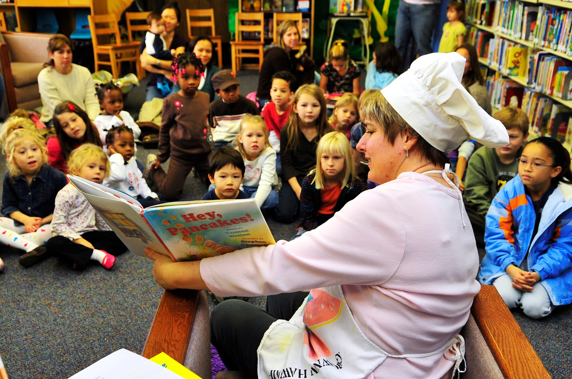 Karleen Jacobson reads "Hey, Pancakes!" to children at the base library during the 2nd annual "Book 'Em and Cook 'Em" program Oct. 3, 2009, Eielson Air Force Base, Alaska. The program entertained more than 40 children who were read stories and then prepared the meal that was read to them. Mrs. Jacobson is a library technician assigned to the 354th Force Support Squadron. (U.S. Air Force photo/Staff Sgt. Christopher Boitz)
