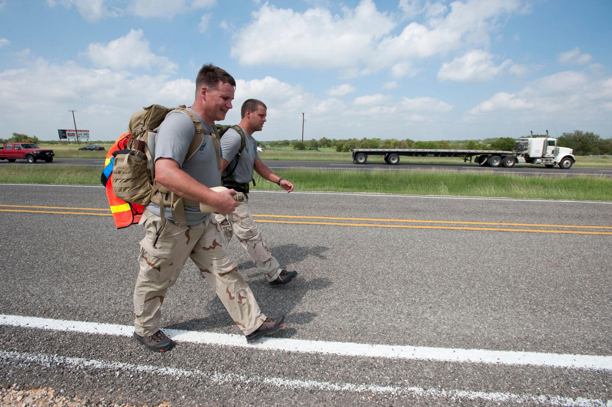 Chief Master Sgt. Tony Travis and Tech. Sgt. Chris Grove, combat controllers with the 23rd Special Tactics Squadron at Hurlburt Field, Fla., walk along I-10 in Texas near mile marker 587 Oct. 6.  The Airmen are participating in the the Special Tactics Memorial Ruck to raise awareness and support for the Special Operations Warrior Foundation and recognize fallen comrades of wars in Iraq and Afghanistan. Six, two-man teams will complete their mission in 10 days by walking 10-15 mile legs around the clock while carrying a ruck weighing at least 50 pounds, which is traditionally used in all training marches. (U.S. Air Force photo/Steve Thurow) 