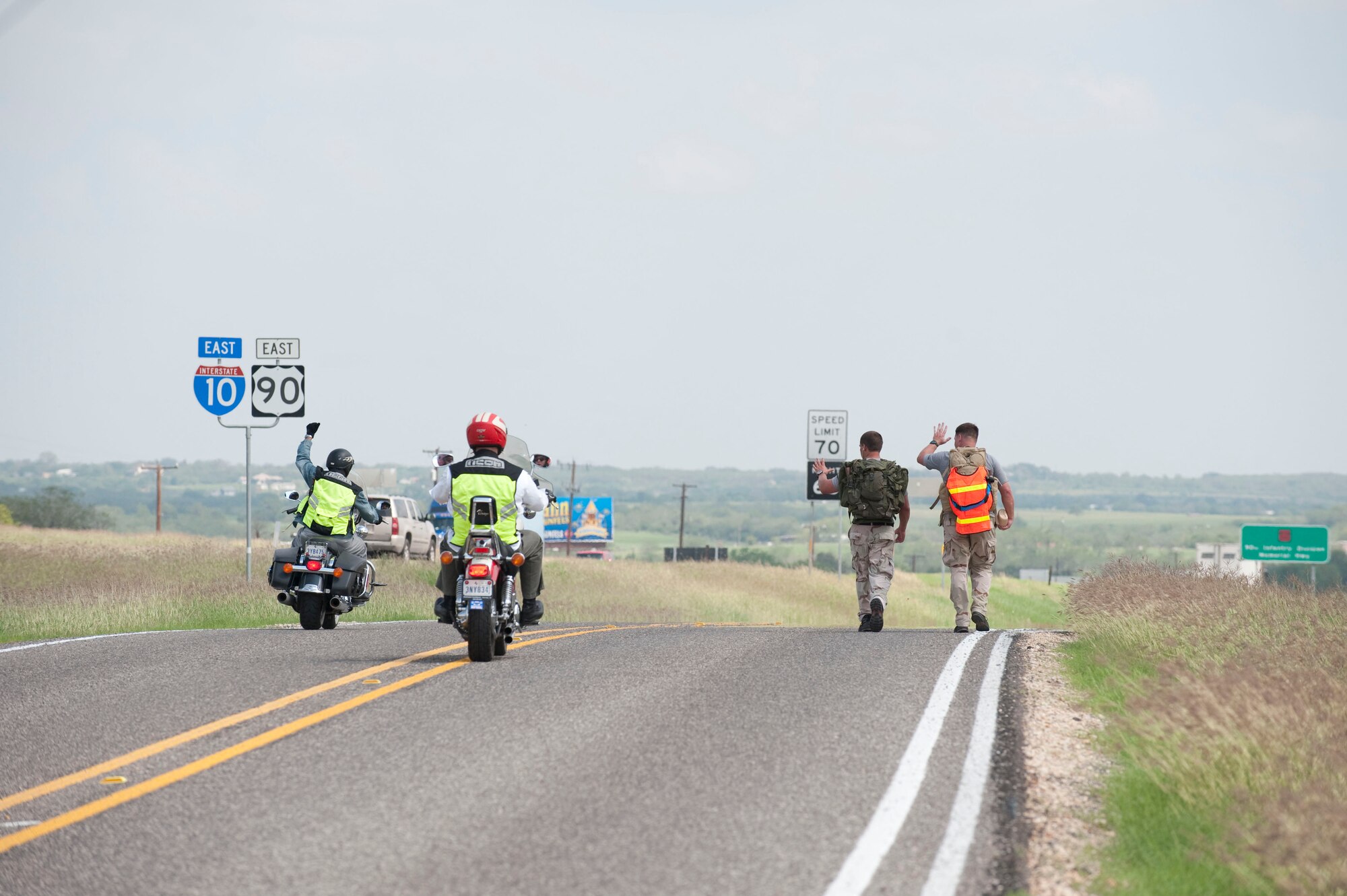 A pair of motorcyclists show support to Chief Master Sgt. Tony Travis and Tech. Sgt. Chris Grove, combat controllers with the 23rd Special Tactics Squadron at Hurlburt Field, Fla., as they walk along I-10 in Texas.  The Special Tactics Memorial Ruck is to raise awareness and support for the Special Operations Warrior Foundation and recognize fallen comrades of wars in Iraq and Afghanistan. Six, two-man teams will complete their mission in 10 days by walking 10-15 mile legs around the clock while carrying a ruck weighing at least 50 pounds, which is traditionally used in all training marches. (U.S. Air Force photo/Steve Thurow)