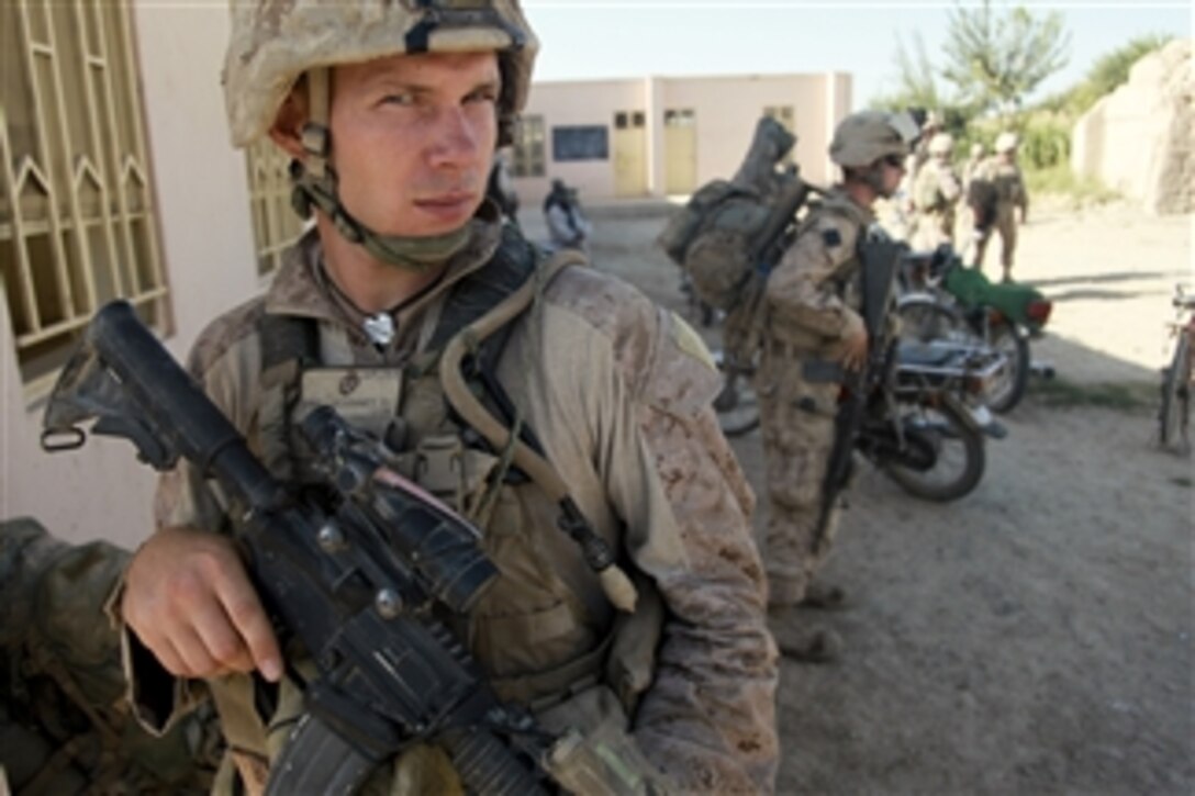 U.S. Navy Petty Officer 2nd Class Shawn McKinney, attached to Alpha Company, 1st Battalion, 5th Marine Regiment, provides security during a shura, or consultation, at a police station in the Nawa district of Helmand province, Afghanistan, on Sept. 29, 2009.  The shura is being held to discuss the needs of the Nawa district.  The 1st Battalion, 5th Marine Regiment is a combat element of Regimental Combat Team 3, which conducts counterinsurgency operations in partnership with Afghan National Security forces in southern Afghanistan.  