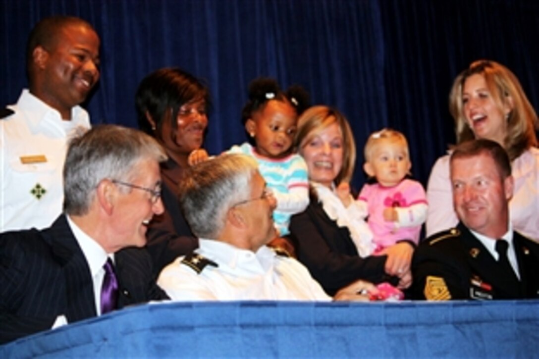 From left, Army Secretary John McHugh, Army Chief of Staff Gen. George W. Casey Jr. and Sgt. Maj. of the Army Kenneth Preston talk with Army families after re-signing the Army Family Covenant at the Association of the U.S. Army's family forum in Washington, D.C., Oct. 5, 2009. 