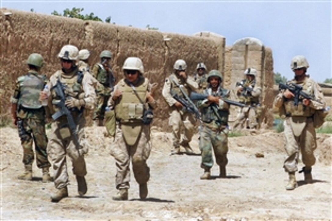 U.S. Marines and Afghan soldiers patrol through several small villages during operation Gator Crawl in Helmand province, Afghanistan, Sept. 23, 2009. The Marines are assigned to the Mine Resistant Ambush Protective Company.