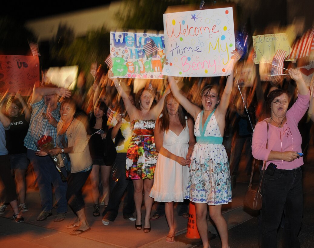 Friends and family of Marine Wing Support Squadron 371 members hold signs welcoming them home at the Marine Corps Air Station in Yuma, Ariz., Oct. 6, 2009. MWSS-371's last group of approximately 150 Marines returned after a seven-month deployment to Afghanistan's Helmand Province. MWSS-371 transferred control of aviation support for Marine Aircraft Group 40 to MWSS-372 from Camp Pendleton, Calif., Sept. 28, 2009. During the deployment, MWSS-371 built the largest expanse of aluminum matting in a combat zone, which was more than 2.2 million square feet. "I can't express how proud I am of these Marines," said Sgt. Maj. John Scott, MWSS-371's sergeant major, who also returned with the last group. "They didn't meet expectations, they exceeded them. It was an incredible deployment."