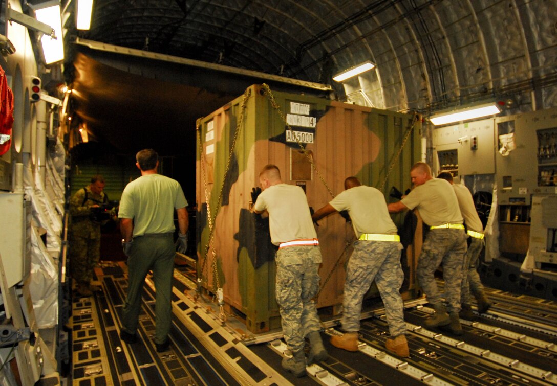 U.S. Airmen help unload a Royal Australian Air Force C-17 Globemaster III Oct. 6 in Padang, Indonesia.  The aircraft brought an Australian Army water purification and civil engineering team to Indonesia to assist in the ongoing relief efforts.  Sixty-nine U.S. Airmen are in Padang as part of the deployment of the U.S. Air Force Humanitarian Assistance Rapid Response Team. (Australian Department of Defence photo/CPL Guy Young)
