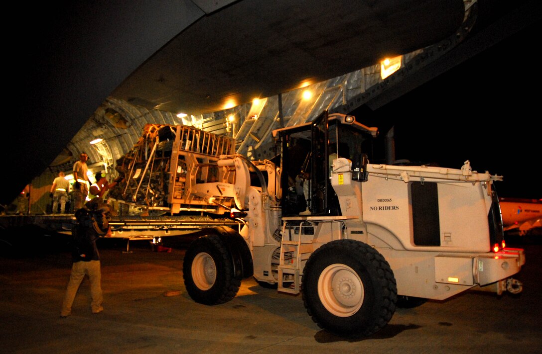 U.S. Airmen help unload a Royal Australian Air Force C-17 Globemaster III Oct. 6 in Padang, Indonesia.  The aircraft brought an Australian Army water purification and civil engineering team to Indonesia to assist in the ongoing relief efforts.  Sixty-nine U.S. Airmen are in Padang as part of the deployment of the U.S. Air Force Humanitarian Assistance Rapid Response Team. (Australian Department of Defence photo/CPL Guy Young)