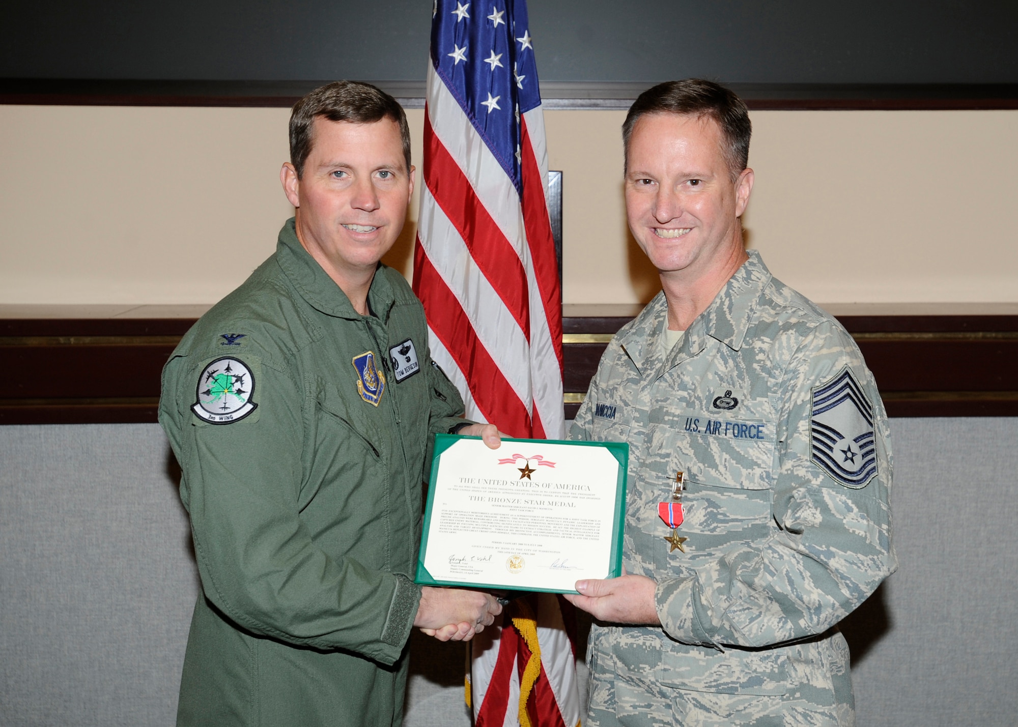 ELMENDORF AIR FORCE BASE, Alaska-- Chief Master Sgt. David Maniccia receives a Bronze Star certificate from Col. Thomas Bergeson, 3rd Wing commander, Oct. 6. (U.S. Air Force photo/Senior Airman Matt Coleman-Foster)