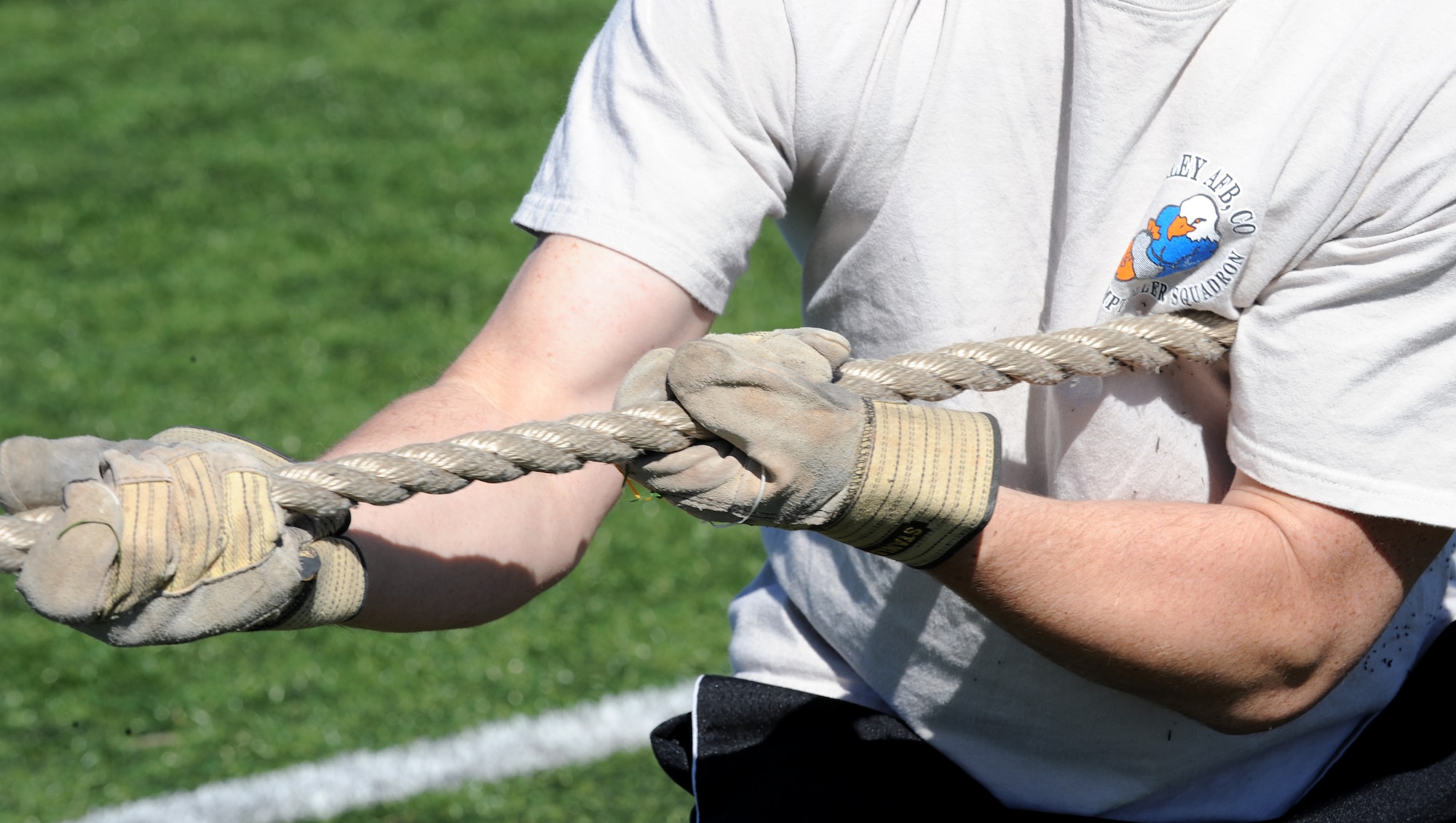 Buckley Air Force Base, Colo. – Nate Smith, 460th Comptroller Squadron hauls in the rope in a tug of war game during Buckley’s Sports and Field Day Oct. 2. (U. S. Air Force photo by Senior Airman John Easterling)