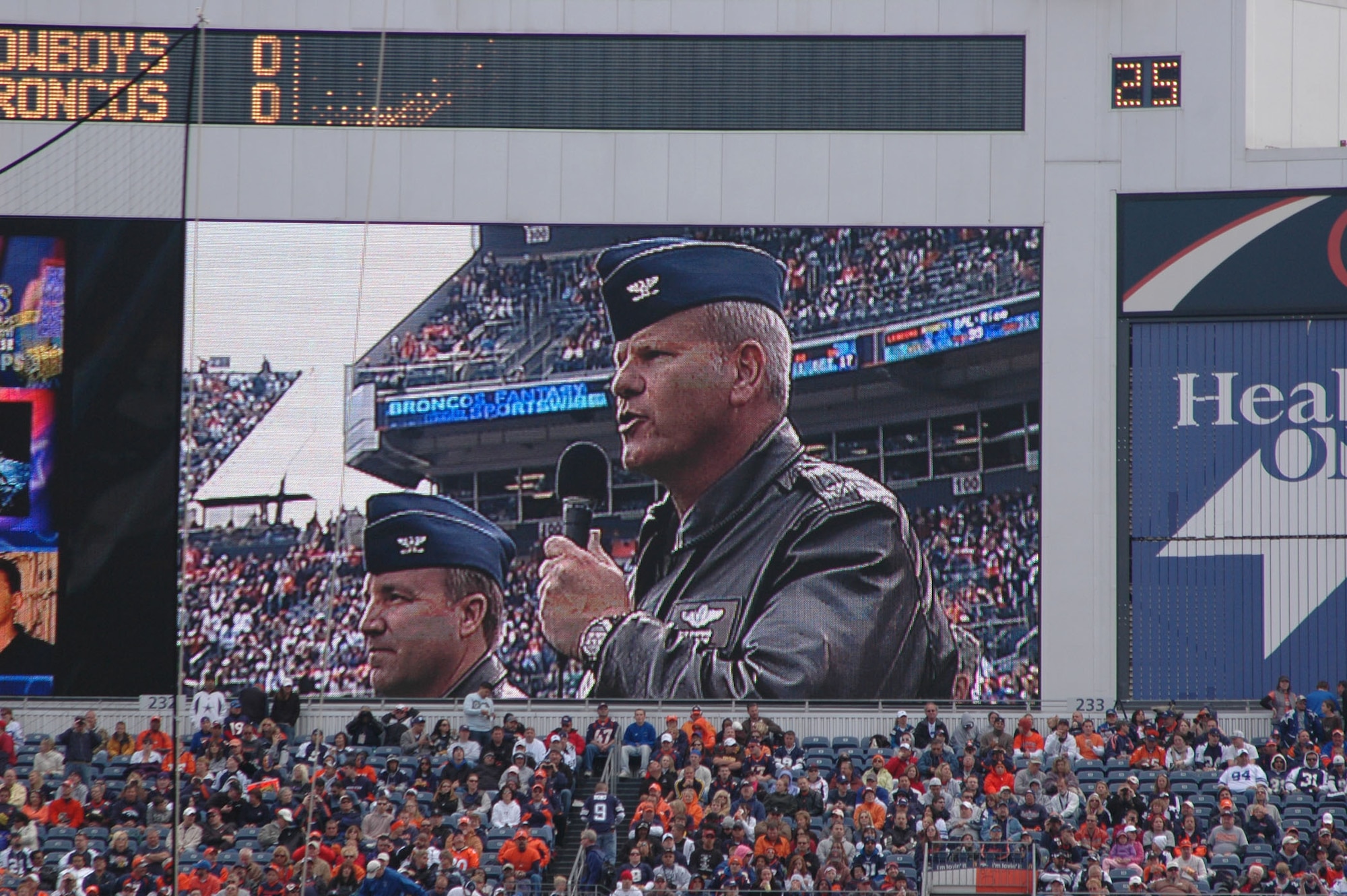 Cols. Bob Chapman (right) and Mark Hustedt speak to Air Force Reserve recruits Oct. 4 during the pre-game activities of the Denver Broncos-Dallas Cowboys NFL football game at Invesco Field in Denver. The Air Force Reserve enlistment was hosted by both the 310th Space Wing and 302nd Airlift Wing, both based in Colorado Springs, Colo. The recruits took the oath of enlistment in front of a crowd of more than 76,400 fans. Colonel Chapman is the 302nd AW's vice commander, while Colonel Hustedt is the space wing's vice commander. (U.S. Air Force photo/Tech. Sgt. Daniel Butterfield)