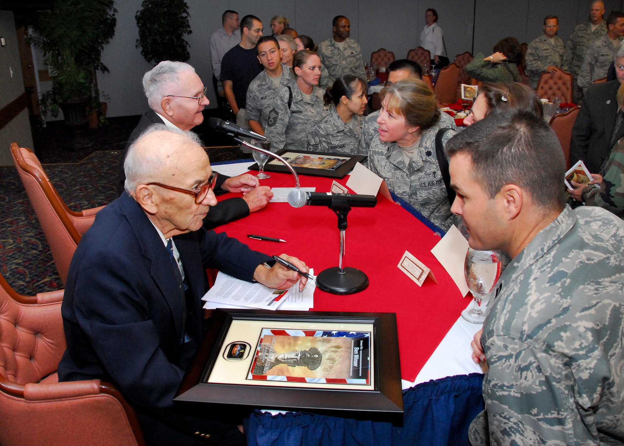 Thurman Taylor and Ben Winser speak with Sheppard members during the Lunch with Legends at the Sheppard Club Oct. 7. The two veterans spoke about their experiences and were honored for their service to their respective branches with two plaques. (U.S. Air Force photo/ Harry Tonemah)