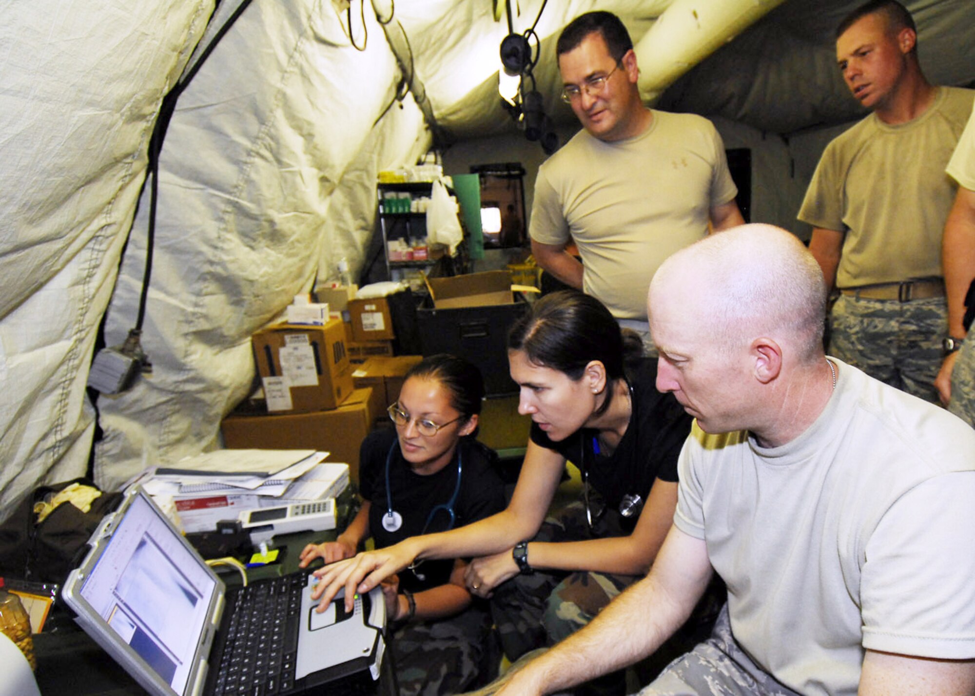 Air Force humanitarian assistance rapid response team members examine a patient's lung x-ray Oct. 7, 2009, in Padang, Indonesia. The HARRT has set up a mobile field hospital to provide medical care to those injured by the recent earthquakes in Indonesia. (U.S. Air Force photo/Staff Sgt. Veronica Pierce)