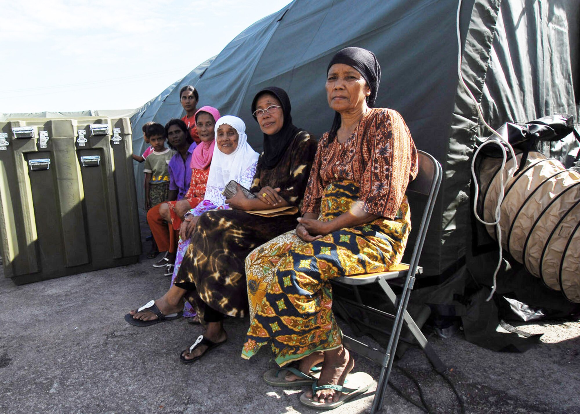 Patients wait to be examined by members of an Air Force humanitarian assistance rapid response team Oct. 7, 2009, in Padang, Indonesia. The HARRT has set up a mobile hospital to provide medical care to those injured by the recent earthquakes in Indonesia. (U.S. Air Force photo/Staff Sgt. Veronica Pierce)