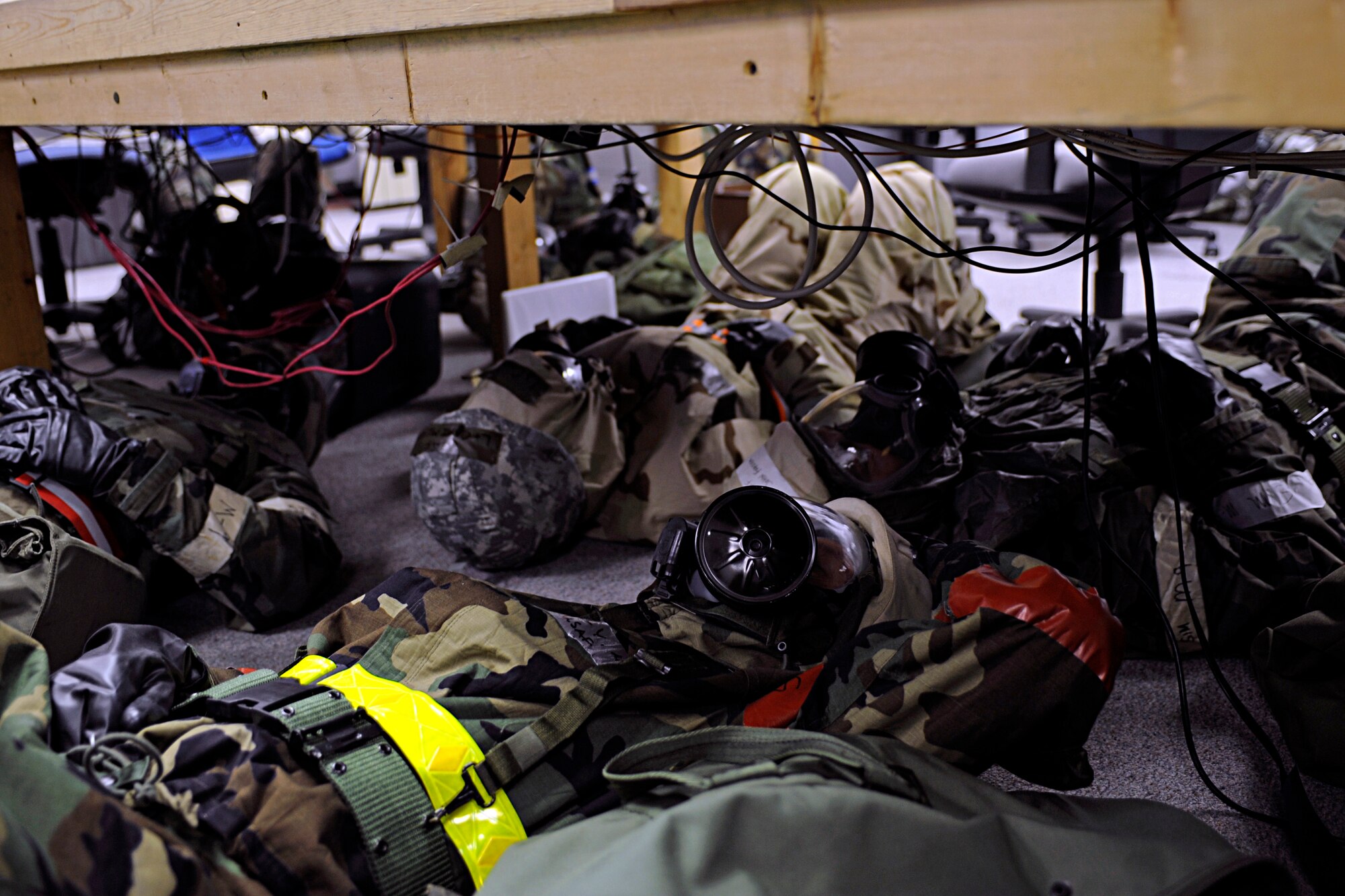 Ellsworth Airman take cover under a table during an alarm red at a Phase II Operational Readiness Exercise here, October 7. The exercise is designed to prepare Airmen for an upcoming Operational Readiness Inspection. (U.S. Air Force photo/Airman 1st Class Matthew Flynn)