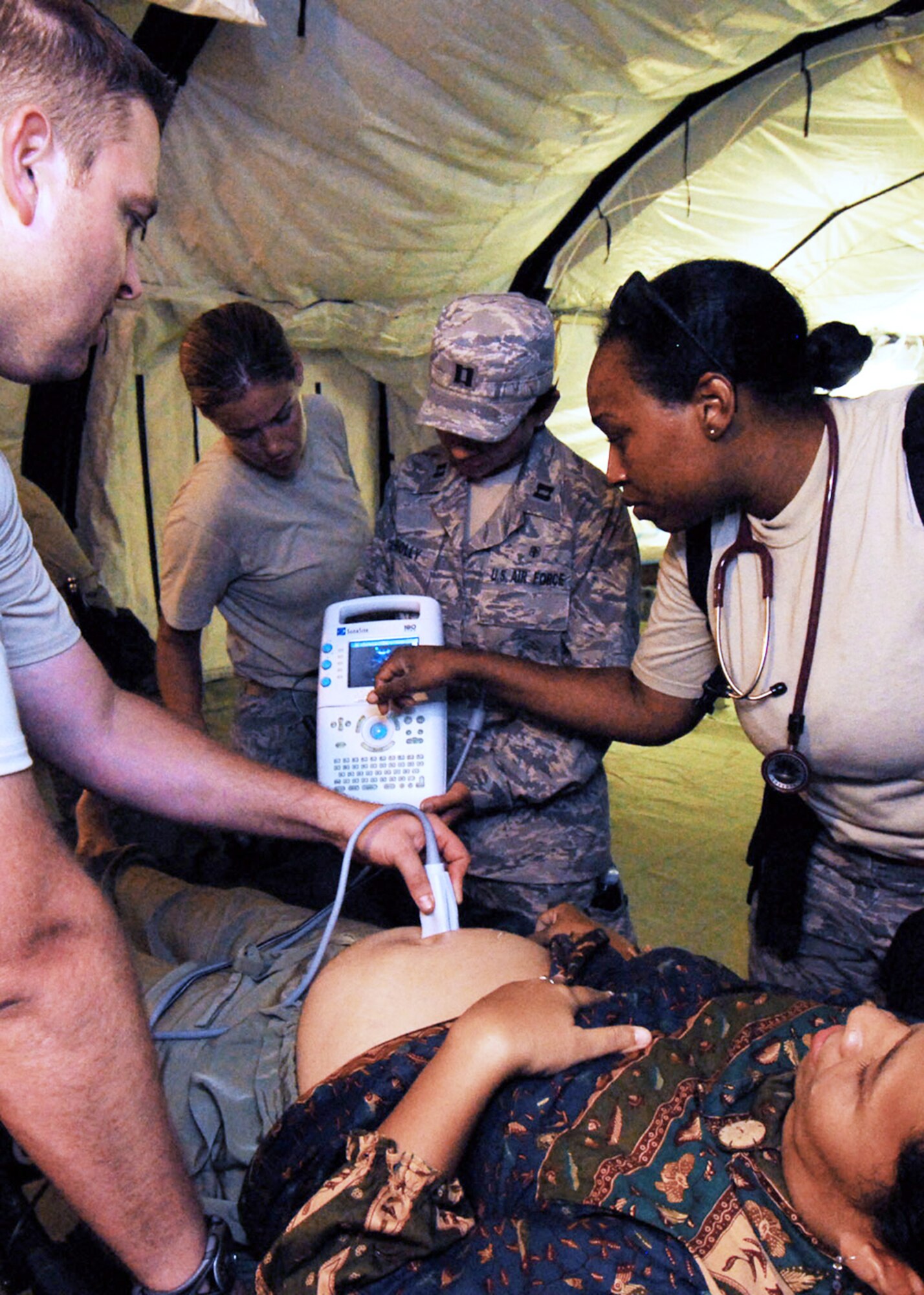 Air Force humanitarian assistance rapid response team medical professionals perform an ultrasound on a pregnant patient Oct. 7, 2009, in a mobile field hospital in Padang, Indonesia. (U.S. Air Force Photo/Staff Sgt. Veronica Pierce)