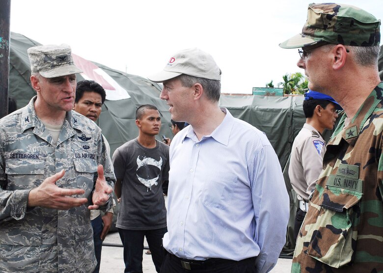 Col. Dan Settergren (left) meets with Ted Osius, U.S. Deputy Charge de Affairs in Indonesia, and Rear Adm. Richard Landolt, Amphibious Force 7th Fleet commander, to explain the Air Force humanitarian assistance rapid response team mission and capabilities in front of the team's mobile field hospital Oct. 6, 2009, in Padang, Indonesia. Colonel Settergren is the 36th Expeditionary Contingency Response Group commander. (U.S. Air Force photo/Staff Sgt. Veronica Pierce)