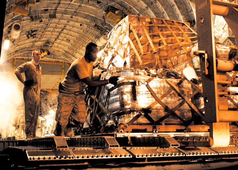 Staff Sgt. Brenton Phillips (right) and Staff Sgt. Norm Metz download a pallet of medical supplies from a C-17 Globemaster III Oct. 5, 2009, at Padang, Indonesia. Sergeant Phillips is air transportation specialist with the 36th Mobility Response Squadron at Andersen Air Force Base, Guam, and is deployed here with an Air Force humanitarian assistance rapid response team to provide medical assistance for those affected by the recent earthquake. Sergeant Metz is a 517th Airlift Squadron loadmaster from Elmendorf AFB, Alaska. (U.S. Air Force photo/Staff Sgt. Veronica Pierce)