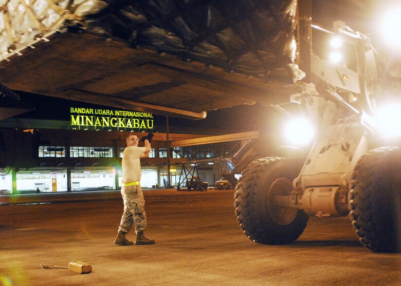 Staff Sgt. Christopher West marshals a forklift carrying medical supplies off of a C-17 Globemaster III Oct. 5, 2009, at Padang, Indonesia. Sergeant West is an air transportation specialist with the 36th Mobility Response Squadron from Andersen Air Force Base, Guam, and is deployed here with the an Air Force humanitarian assistance rapid response team to provide medical assistance for those affected by the recent earthquake. (U.S. Air Force photo/Staff Sgt. Veronica Pierce)