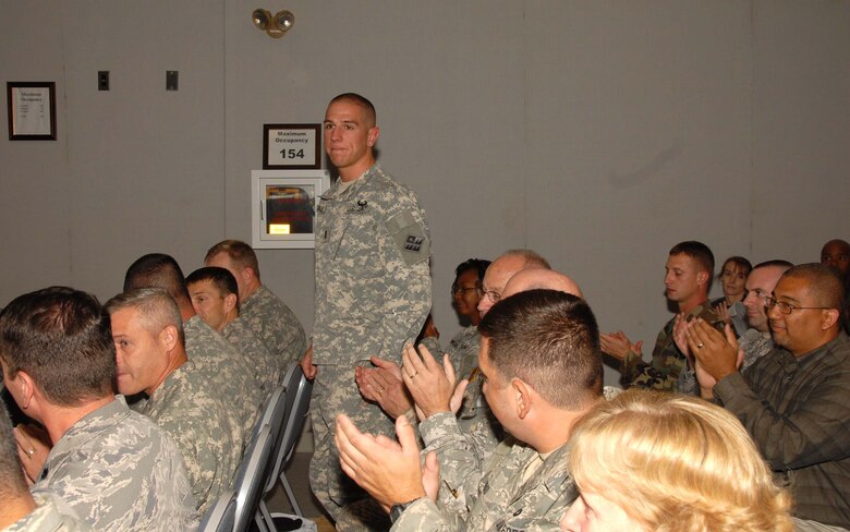 Delaware Army National Guard 1st Lt. Michael Malloy, a resident of Newark, Del., is recognized with applause by his class peers during the Oct. 3, 2009 graduation ceremony held at Del. ANG Headquarters in New Castle, Del. for the 19 graduates of the first class of the Delaware National Guard's Delaware Leadership Academy. Lt. Malloy completed the 18 credits in the graduate program while deployed to Baghdad, Iraq. (U.S. Air Force photo/Tech. Sgt. Tracy Childs)