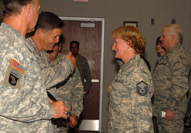 Air Force Brigadier Gen. Hugh Broomall, Deputy Adjutant General, Delaware National Guard, returns the salute of Master Sgt. Eunice Kindle, a resident of Elkton, Md., during the Oct. 3, 2009 graduation ceremony for the 19 graduates of the first class of the Delaware National Guard's Delaware Leadership Academy held at Del. ANG Headquarters in New Castle, Del. Sgt. Kindle was one of the graduates of the program during its inaugural academic year. (U.S. Air Force photo/Tech. Sgt. Tracy Childs)