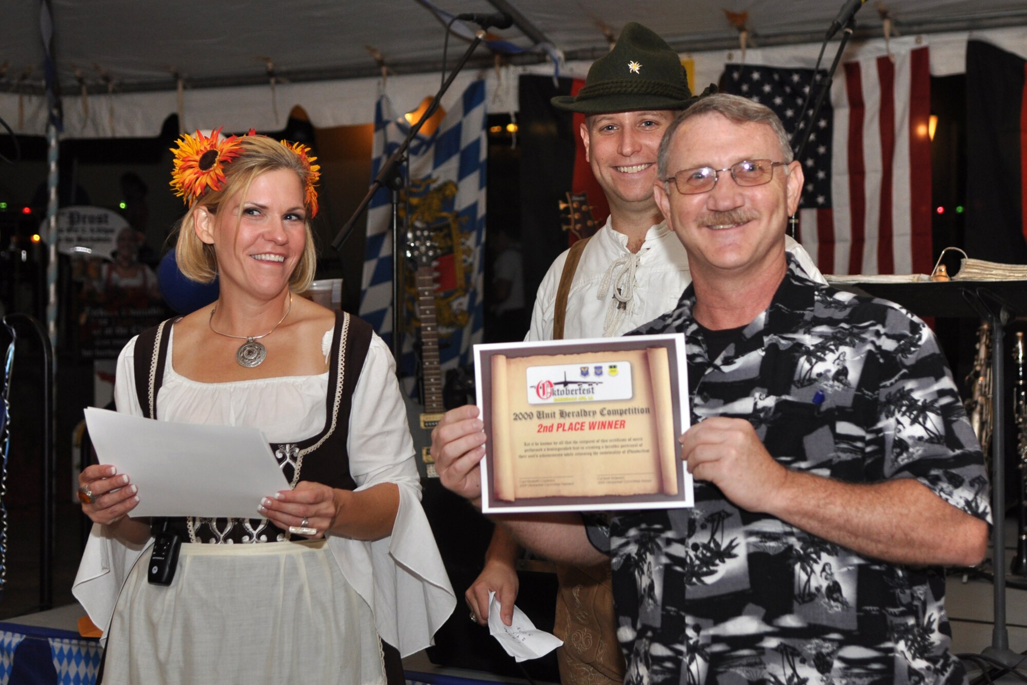 Tech. Sgt. Jeff Walston, 917th Wing, public affairs technician, accepts the prize for 2nd Place in the shield contest on behalf of the 917th Wing during the awards presentations at the 2nd Annual Oktoberfest celebration at Barksdale Air Force Base, La., October 2, 2009. Sergeant Walston who was working the event as a photographer graciously accepted the award when the other 917th Wing members attending the celebration, for some reason while enjoying the festivities, did not respond to the winning announcement. (U.S. Air Force photo/Airman 1st Class Joseph Boals)