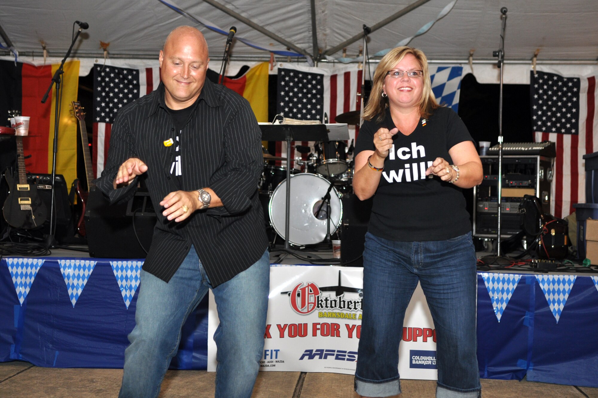 Colonel West Anderson, 8th Air Force headquarters chief of staff, and his wife Janet, do the hand jive during activities at the 2nd Annual Oktoberfest celebration at Barksdale Air Force Base, La., October 2, 2009. For the price of admission partygoers enjoyed an authentic German meal, which included bratwurst, schnitzel, German potato salad, and a roll; along with 2 beverages and a commemorative Oktoberfest mug. Side items such as turkey legs and sausage on a stick were also available. Partygoers talked, ate, sang and danced, while some others participated in the keg rolling, costume and yodeling contests. (U.S. Air Force photo/Tech. Sgt. Jeff Walston)