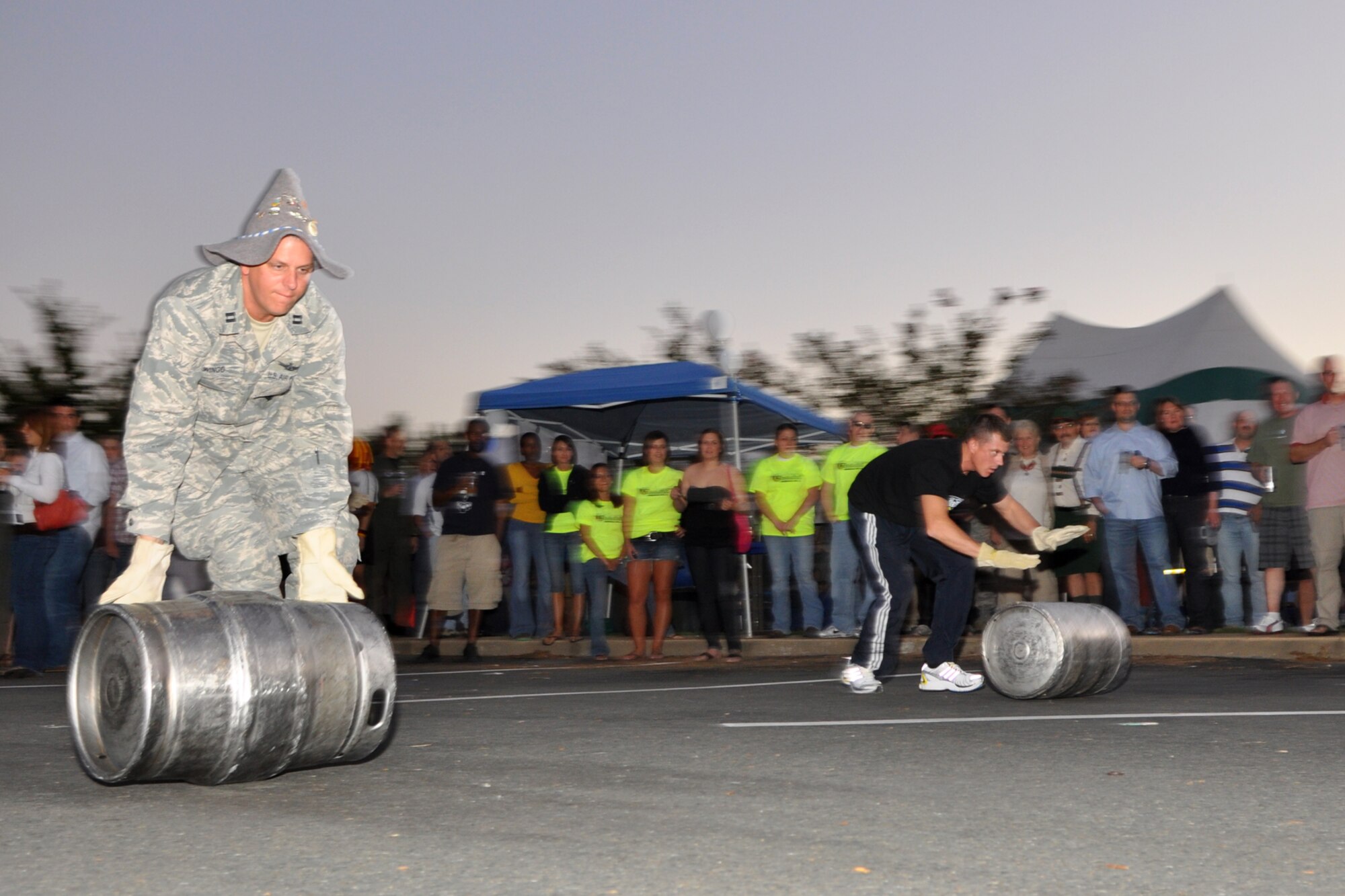 Capt. Beau Wingo, Air Force Global Strike Command, missile operator, takes the lead and the win over Capt. Daniel Gregorich, Air Combat Command, Logistics Readiness Squadron, logistics readiness officer, in this heat of the keg roll races at the 2nd Annual Oktoberfest celebration at Barksdale Air Force Base, La., October 2, 2009. For the price of admission partygoers enjoyed an authentic German meal, which included bratwurst, schnitzel, German potato salad, and a roll; along with 2 beverages and a commemorative Oktoberfest mug. Side items such as turkey legs and sausage on a stick were also available. Partygoers talked, ate, sang and danced, while some others participated in the keg rolling, costume and yodeling contests. (U.S. Air Force photo/Tech. Sgt. Jeff Walston)