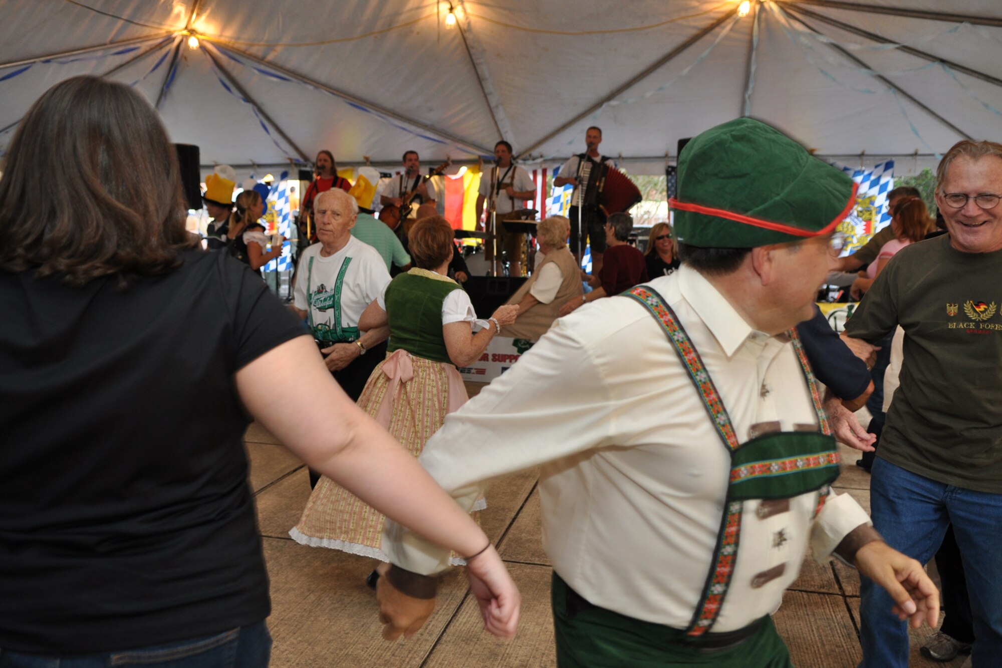 Dancing the night away, could have been the theme for the 2nd Annual Oktoberfest celebration at Barksdale Air Force Base, La., October 2, 2009. For the price of admission partygoers enjoyed an authentic German meal, which included bratwurst, schnitzel, German potato salad, and a roll; along with 2 beverages and a commemorative Oktoberfest mug. Side items such as turkey legs and sausage on a stick were also available. Partygoers talked, ate, sang and danced, while some others participated in the keg rolling, costume and yodeling contests. (U.S. Air Force photo/Tech. Sgt. Jeff Walston)