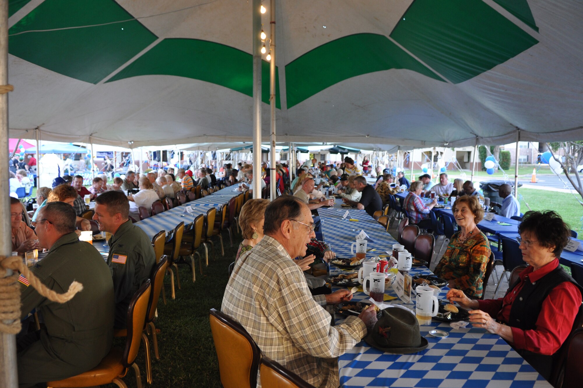 Attendees sit down for a complete authentic German meal at the 2nd Annual Oktoberfest celebration at Barksdale Air Force Base, La., October 2, 2009. The price of admission included bratwurst, schnitzel, German potato salad, and a roll; along with 2 beverages and a commemorative Oktoberfest mug. Side items such as turkey legs and sausage on a stick were also available. Partygoers talked, ate, sang and danced, while others participated in the keg rolling, costume and yodeling contests. (U.S. Air Force photo/Tech. Sgt. Jeff Walston)