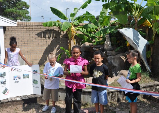 The 4H Kids 4 Change president Antoinette Lewis prepares to cut the ribbon and officially open the simulated ecosystem Oct. 7 at the Youth Center on Eglin Air Force Base, Fla.  (Air Force photo/Airman 1st Class Chris Jacobs)

