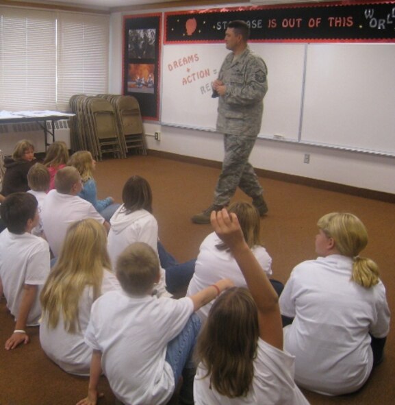 MINOT AIR FORCE BASE, N.D. -- Master Sgt. Brian Westerman, 5th Force Support Squadron Airman and Family Readiness Center noncommissioned officer-in-charge, talks with STARBASE students participating in a service-learning project that supports deployed troops called Operation GLOBAL FREEDOM.  During the school year, STARBASE North Dakota is partnering with the Airman and Family Readiness Center collecting items for American troops who are deployed across the world. (Courtesy photo)