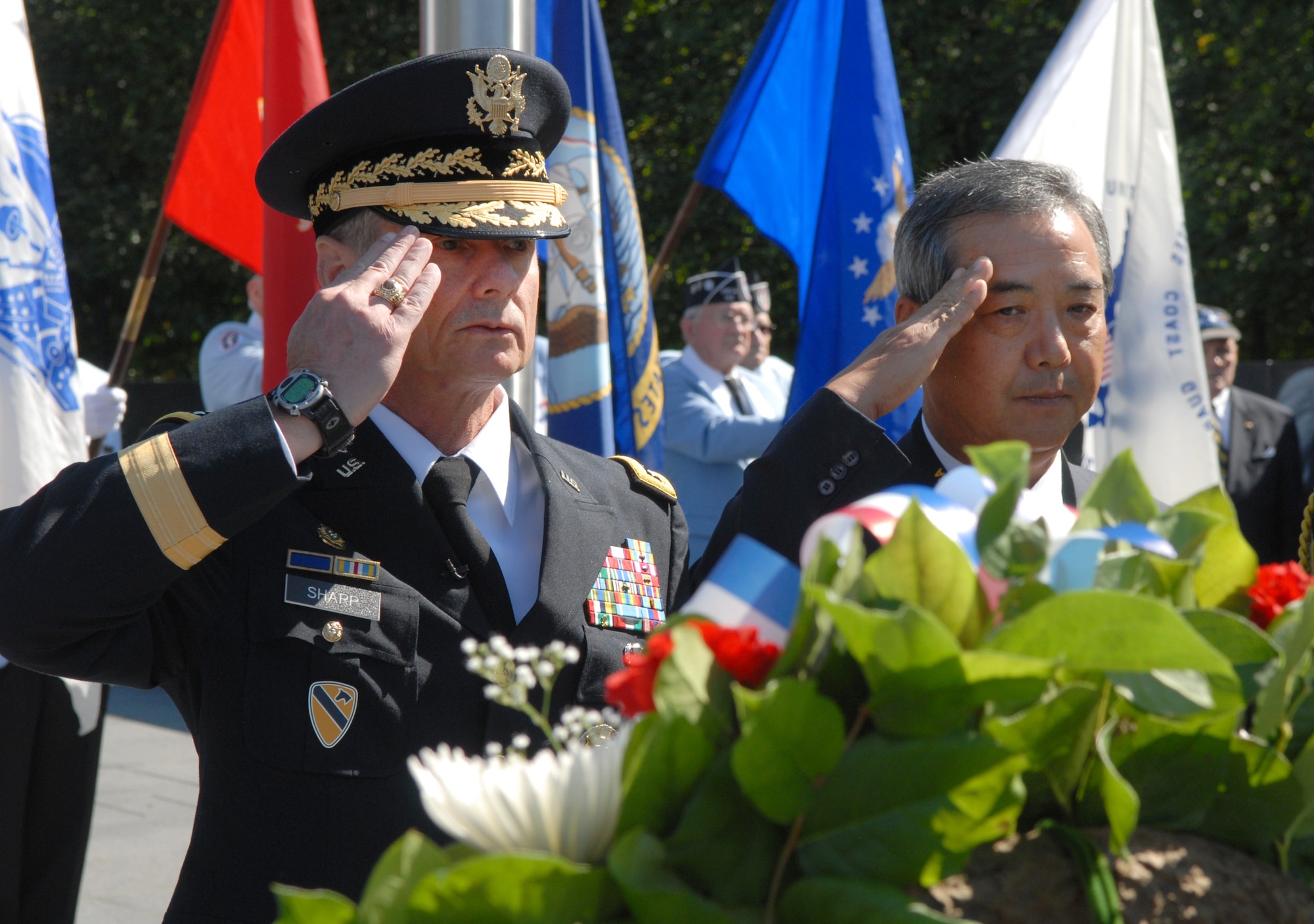 Army Gen. Walter L. Sharp, commander of U.S. Forces Korea, and Jung-ki "Rocky" Park, Korean Corporate Members of the Association of the United States Army, render honors during a wreath-laying ceremony at the Korean War Veterans Memorial in Washington, D.C., Oct. 5, 2009. (Defense Department photo/Sgt. 1st Class Michael J. Carden)  