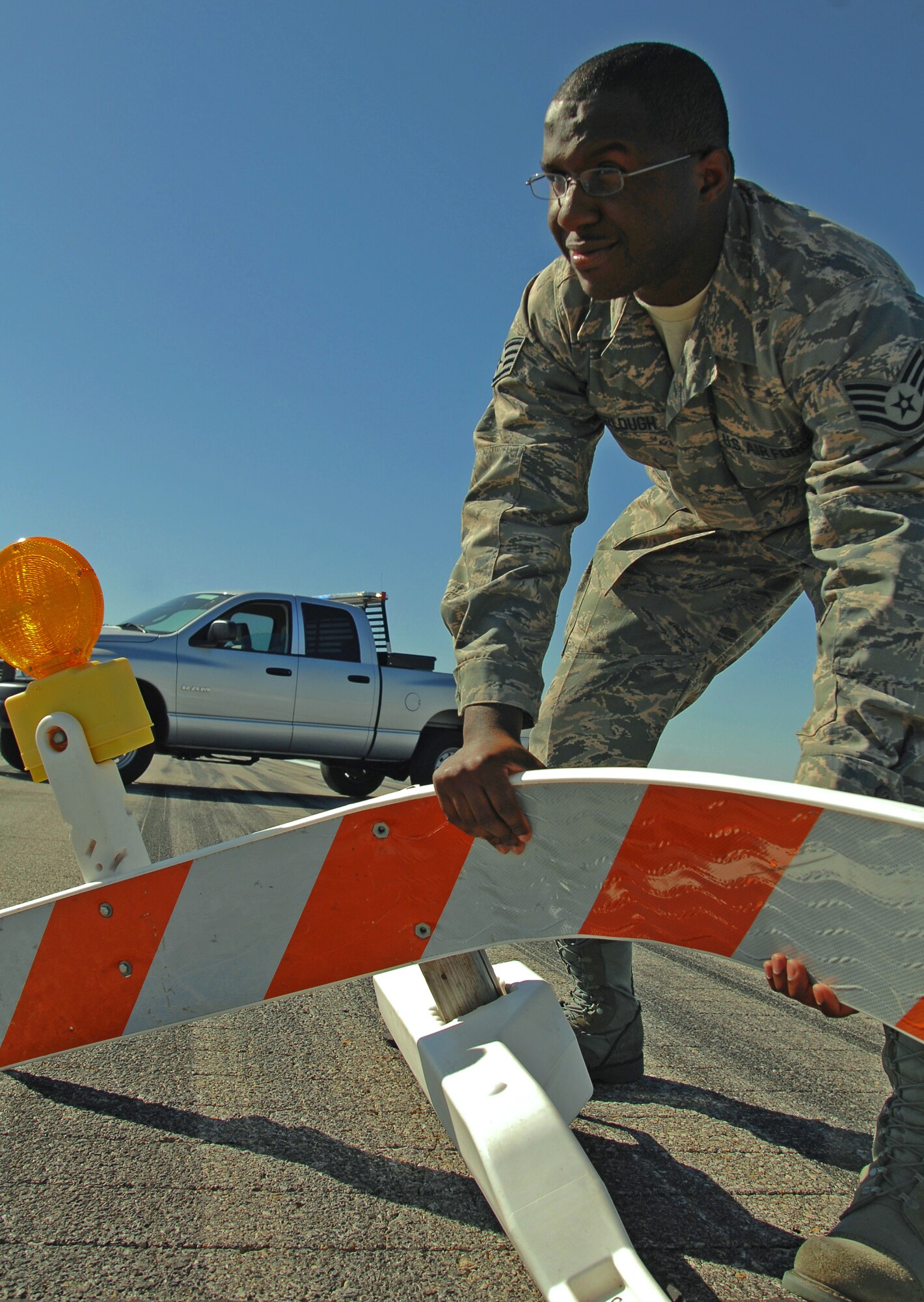 Staff Sgt.  Larry Furlough, 22nd Operations Support Squadron, fixes a flight line barrier knocked over and bent by the wind, Oct. 2, 2009, at McConnell Air Force Base, Kan.  The Ellenwood, Ga., native is the non-commissioned officer in charge of airfield management training. (U.S Air Force photo/Senior Airman Jessica Lockoski)