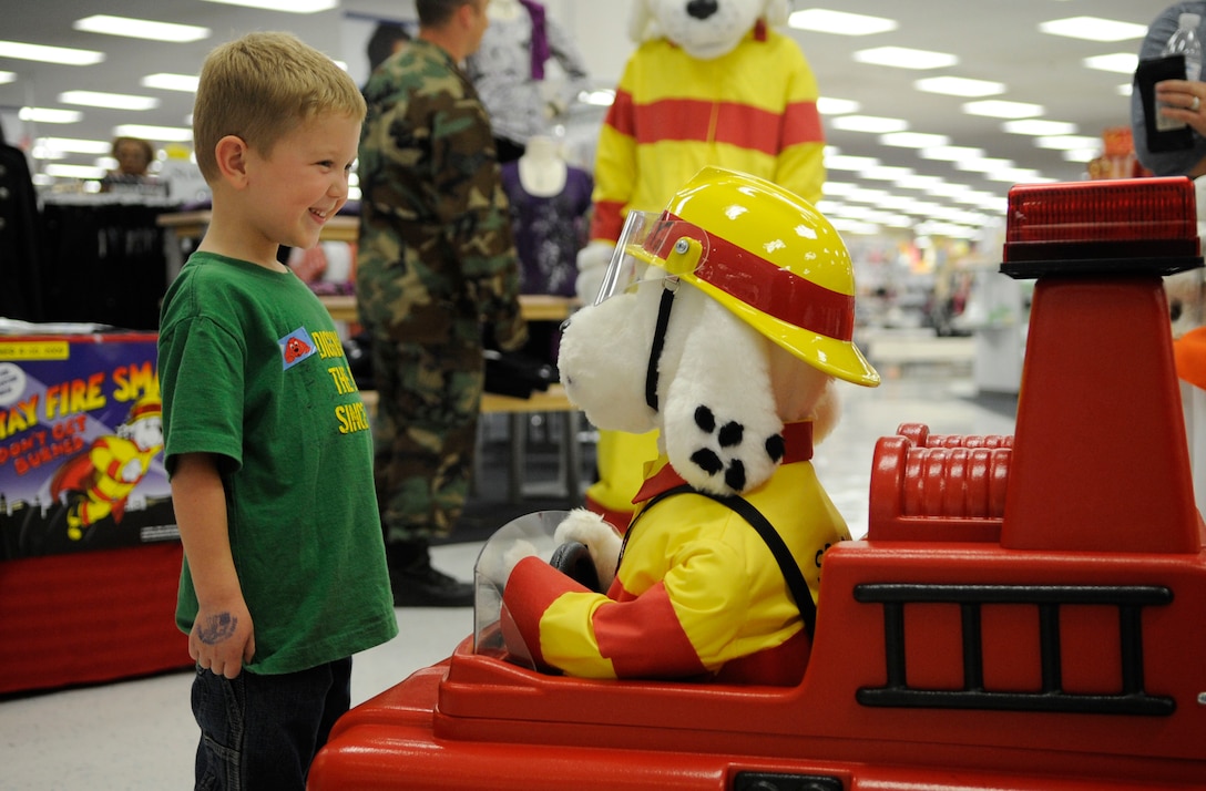 LANGLEY AIR FORCE BASE, Va - Nate Gouker, son of Lt. Col. Shane Gouker, United States Marine Corps, talks to Sparky the robot about the magic numbers 911 here Oct. 6. Sparky and base firefighters are teaching children fire safety during Fire Prevention Week, Oct 4-10.  (U.S. Air Force photo/ Senior Airman Dana Hill)
