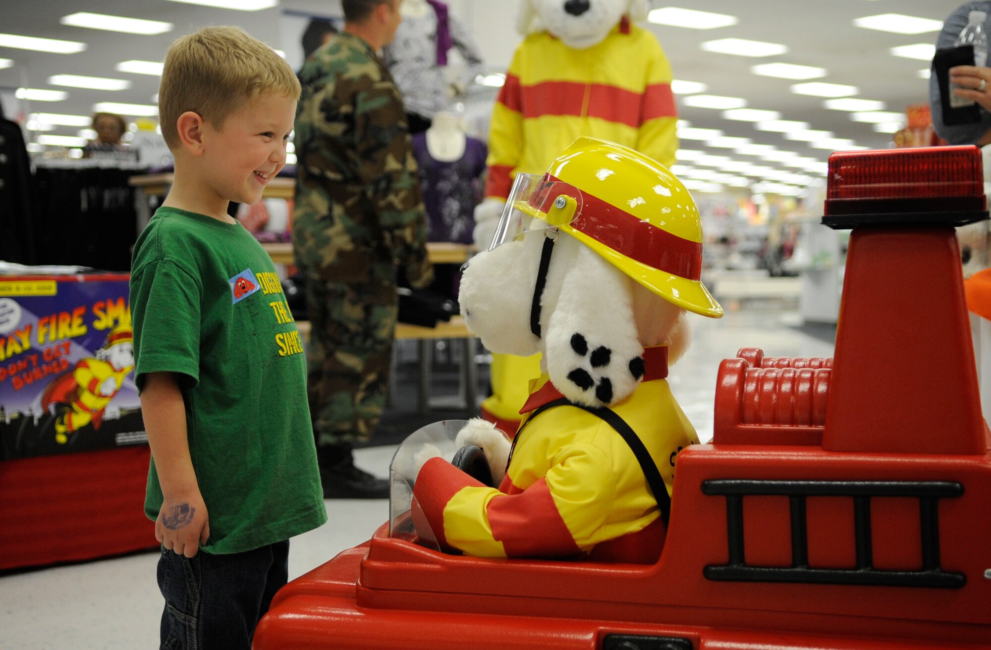 LANGLEY AIR FORCE BASE, Va - Nate Gouker, son of Lt. Col. Shane Gouker, United States Marine Corps, talks to Sparky the robot about the magic numbers 911 here Oct. 6. Sparky and base firefighters are teaching children fire safety during Fire Prevention Week, Oct 4-10.  (U.S. Air Force photo/ Senior Airman Dana Hill)
