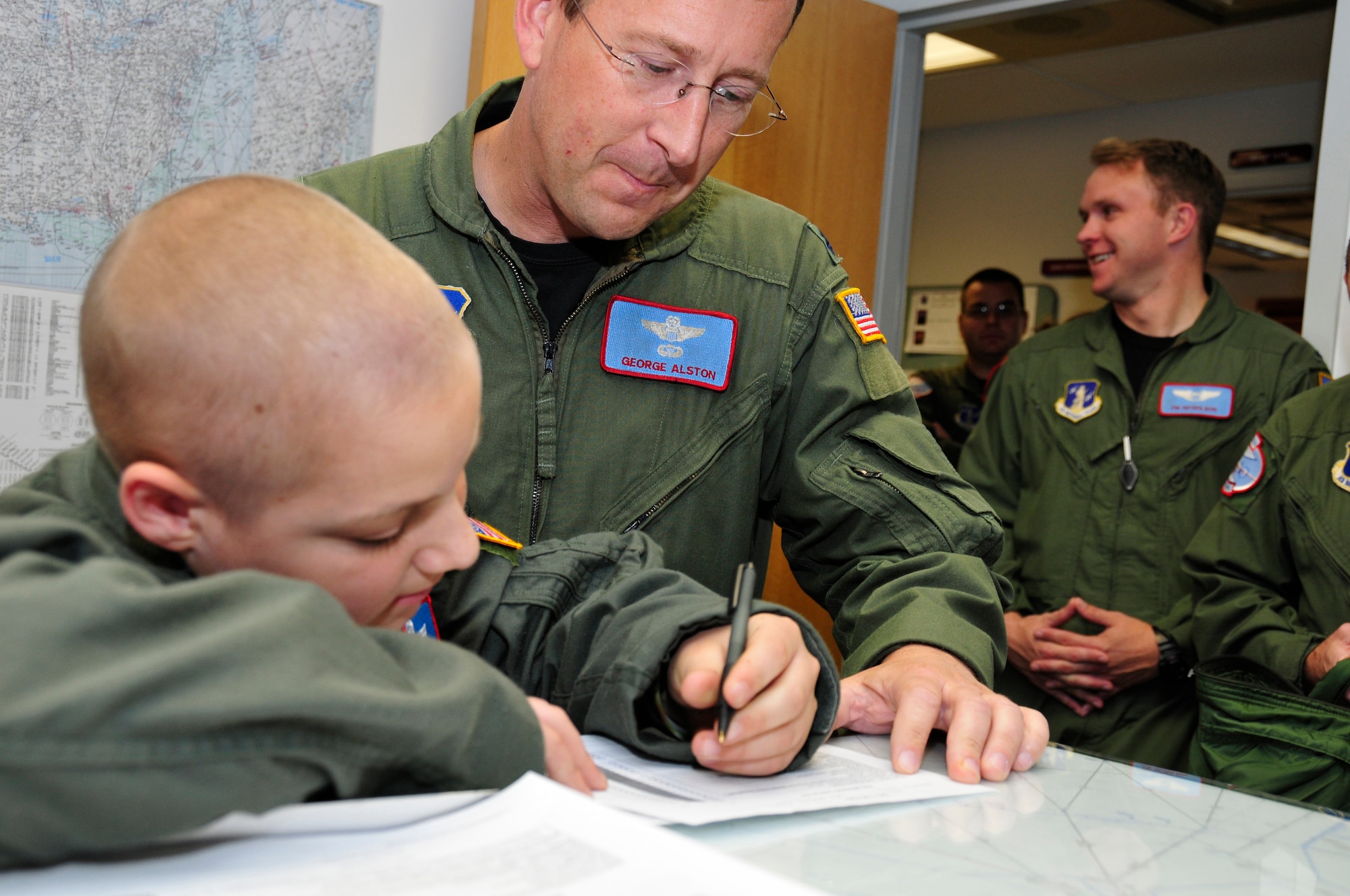 Lt. Col. George Alston oversees as Jacob Kaminski signs his orders for a mock LC-130 mission. Jacob, 9, came to the base Oct. 6 to fulfill his dream of being a soldier for a day. After spending the day with the Army, he came to the base to see what it was like to be a pilot with the 109th Airlift Wing. Jacob has been diagnosed with leukemia. (U.S. Air Force photo by Master Sgt. Willie Gizara)