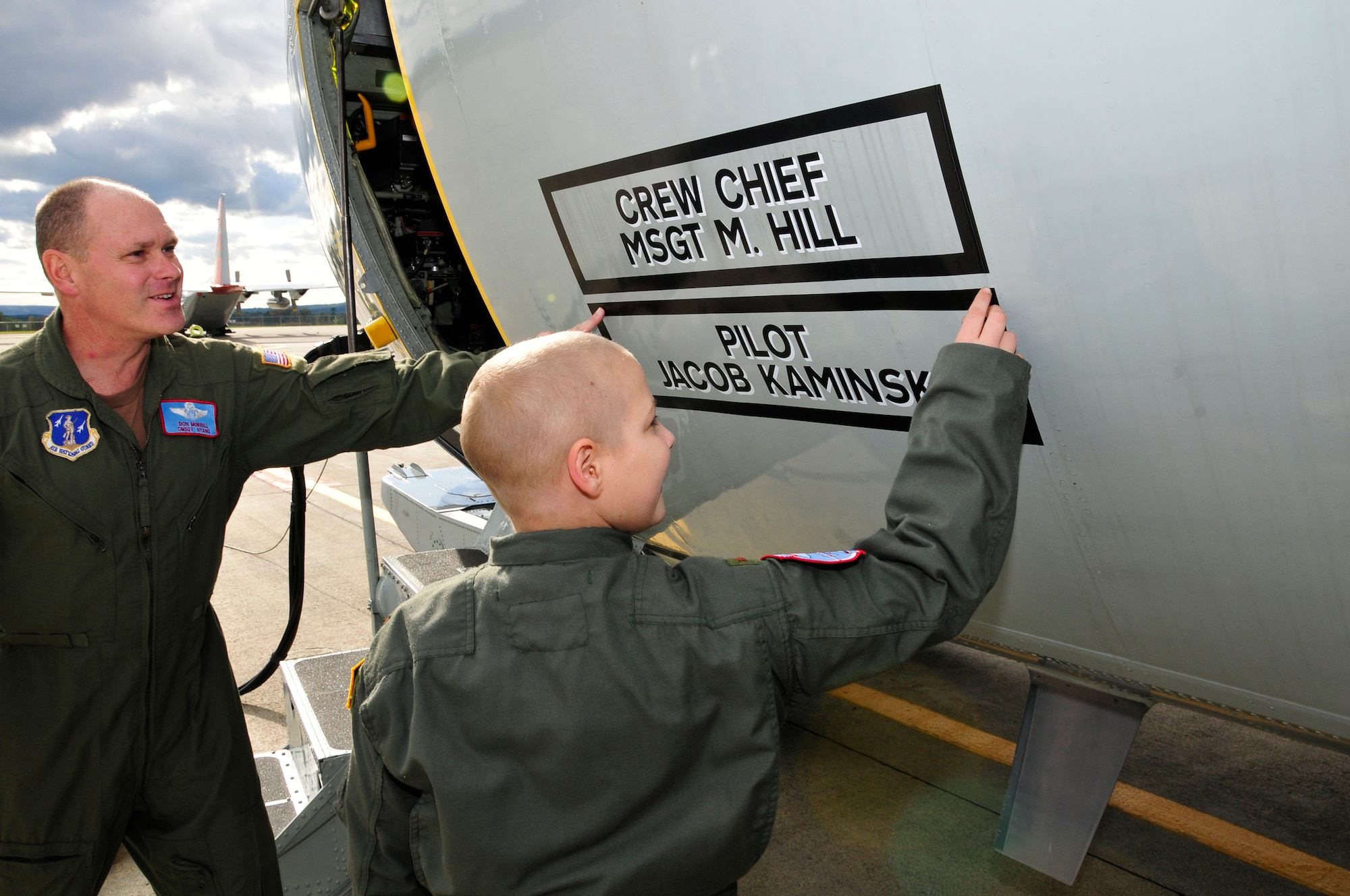 Chief Master Sgt. Don Morrell shows Jacob Kaminski his name on the LC-130 aircraft. Jacob, 9, came to the base Oct. 6 to fulfill his dream of being a soldier for a day. After spending the day with the Army, he came to the base to see what it was like to be a pilot with the 109th Airlift Wing. Jacob has been diagnosed with leukemia. (U.S. Air Force photo by Master Sgt. Willie Gizara)