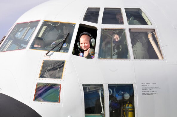 Jacob Kaminski gives the thumbs-up sign out of the cockpit after starting up the engine on an LC-130 Hercules. Jacob, 9, came to the base Oct. 6 to fulfill his dream of being a soldier for a day. After spending the day with the Army, he came to the base to see what it was like to be a pilot with the 109th Airlift Wing. Jacob has been diagnosed with leukemia. (U.S. Air Force photo by Master Sgt. Willie Gizara)