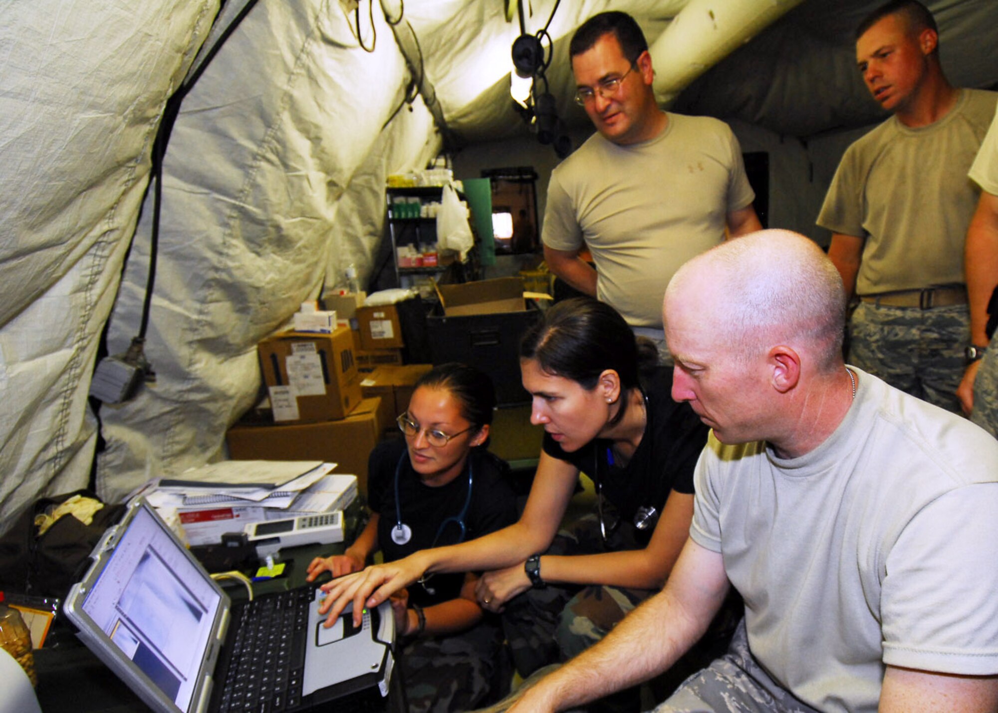 PADANG, Indonesia -- Air Force Humanitarian Assistance Rapid Response Team members examine a patient's lung x-ray Oct. 7. The HARRT has set up a mobile field hospital to provide medical care to those injured by the recent earthquakes here. (U.S. Air Force photo/Staff Sgt. Veronica Pierce)